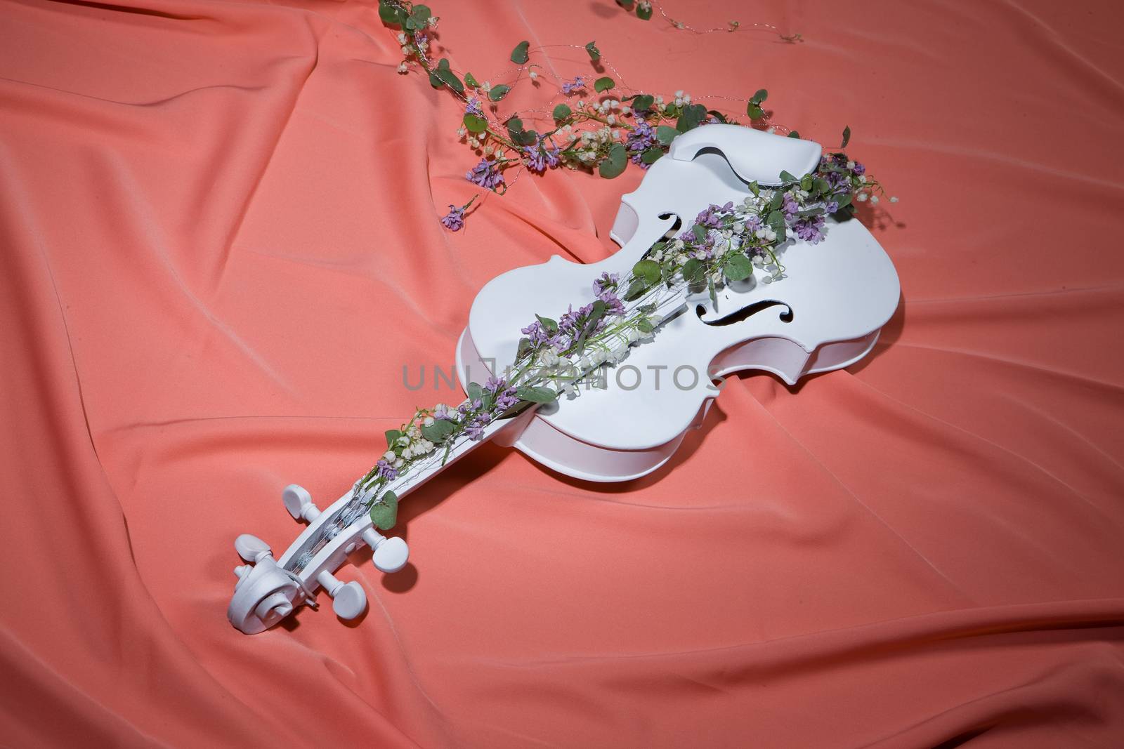 White decorative violin and flower composition