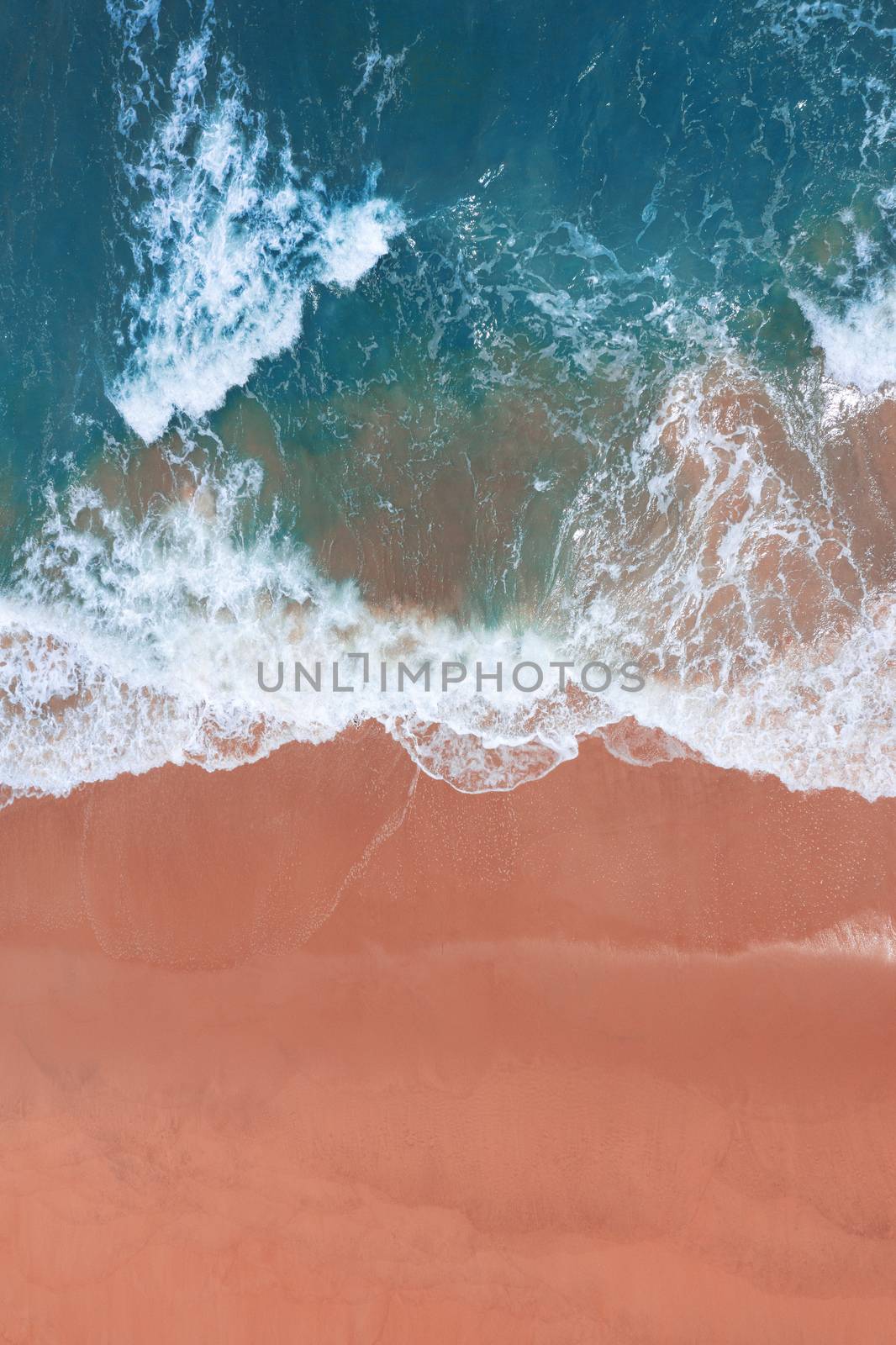 Aerial view of pink beach and blue ocean wave. by gutarphotoghaphy