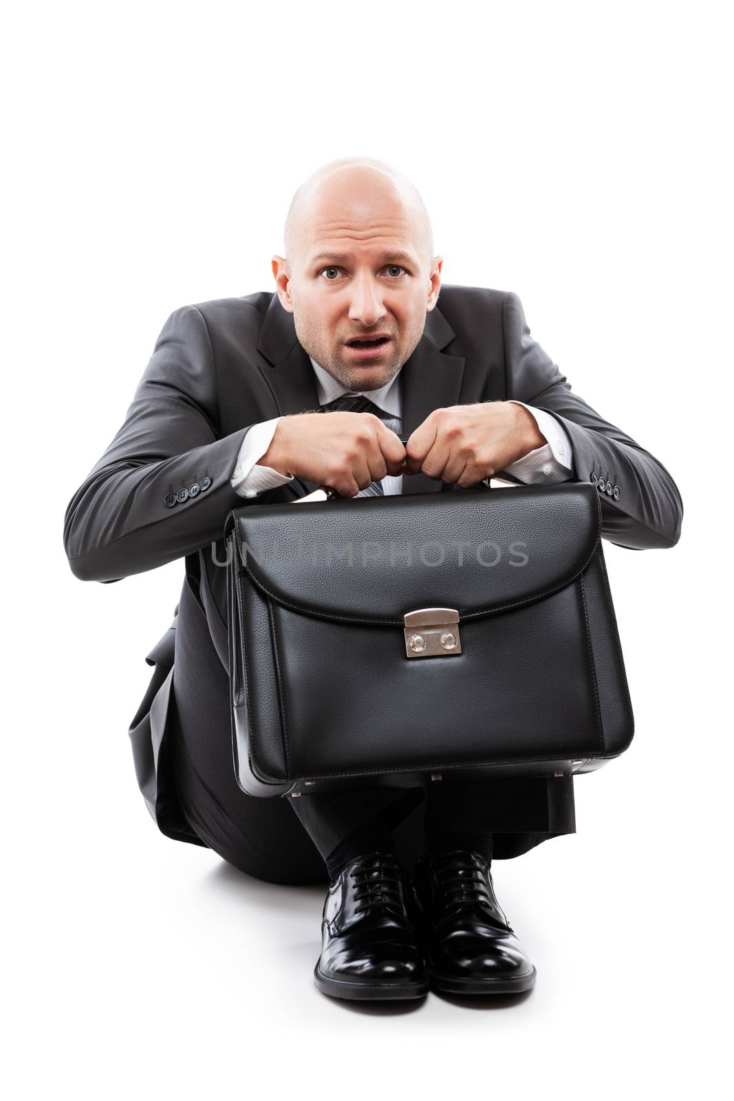 Unhappy scared or terrified businessman in depression hand holding briefcase by ia_64