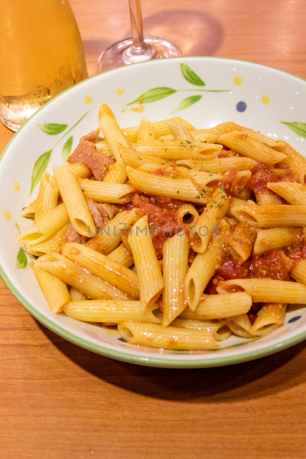 Pasta alfredo penne with tomato based sauce in plate