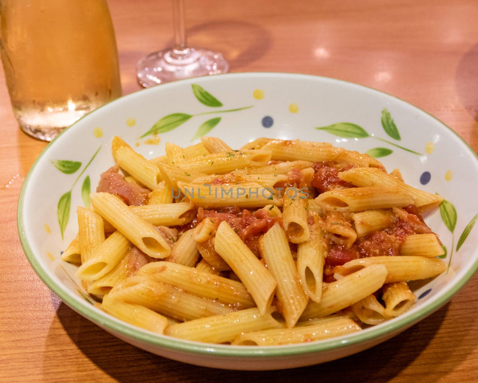 Pasta alfredo penne with tomato based sauce in plate