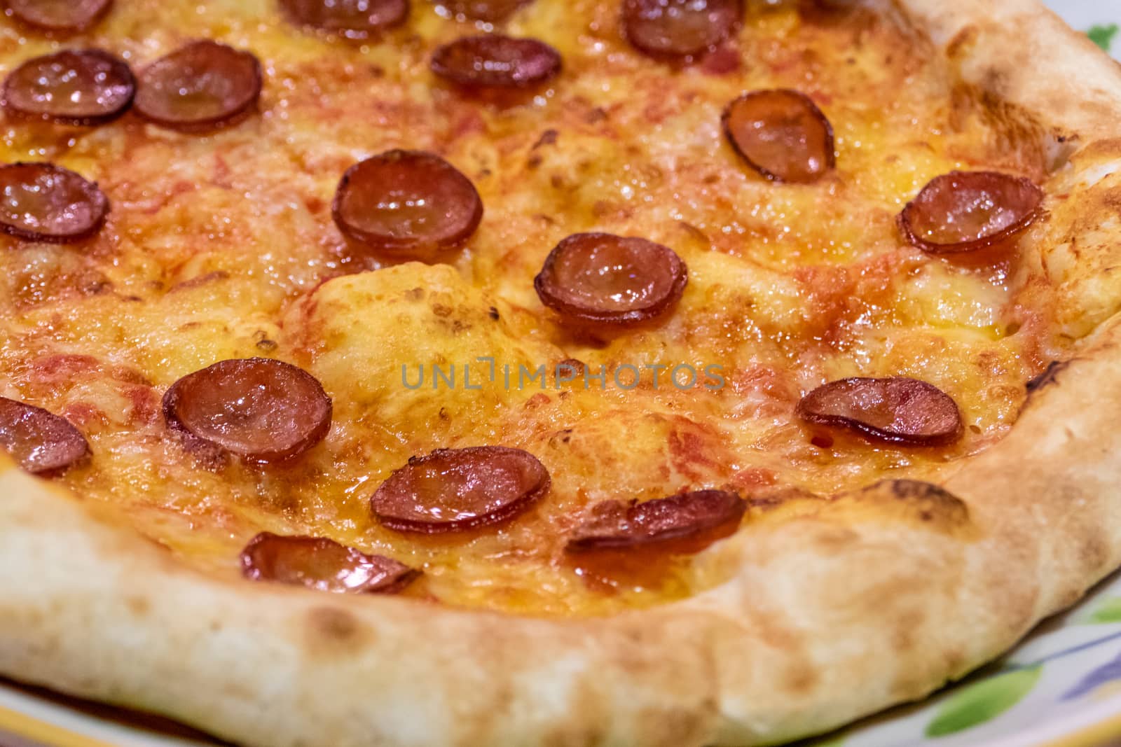 Chorizo sausage pizza with cheese in plate