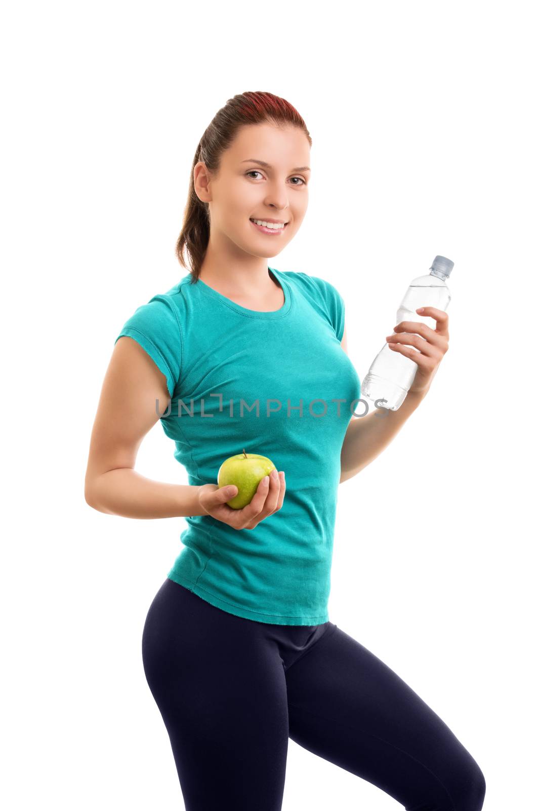 A portrait of a beautiful fit young girl holding an apple and a bottle of water, isolated on white background. Water and snack after my workout.