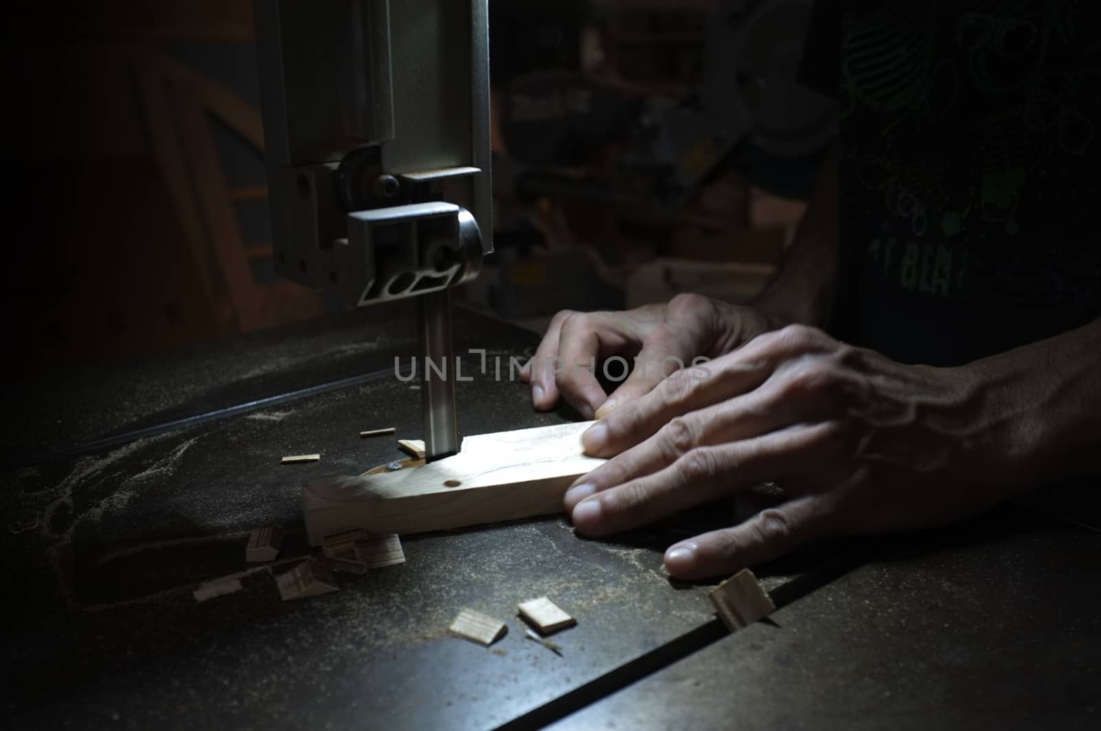 Carpenter builder working with electric jigsaw and wood. Woodworker cutting a piece of wood  