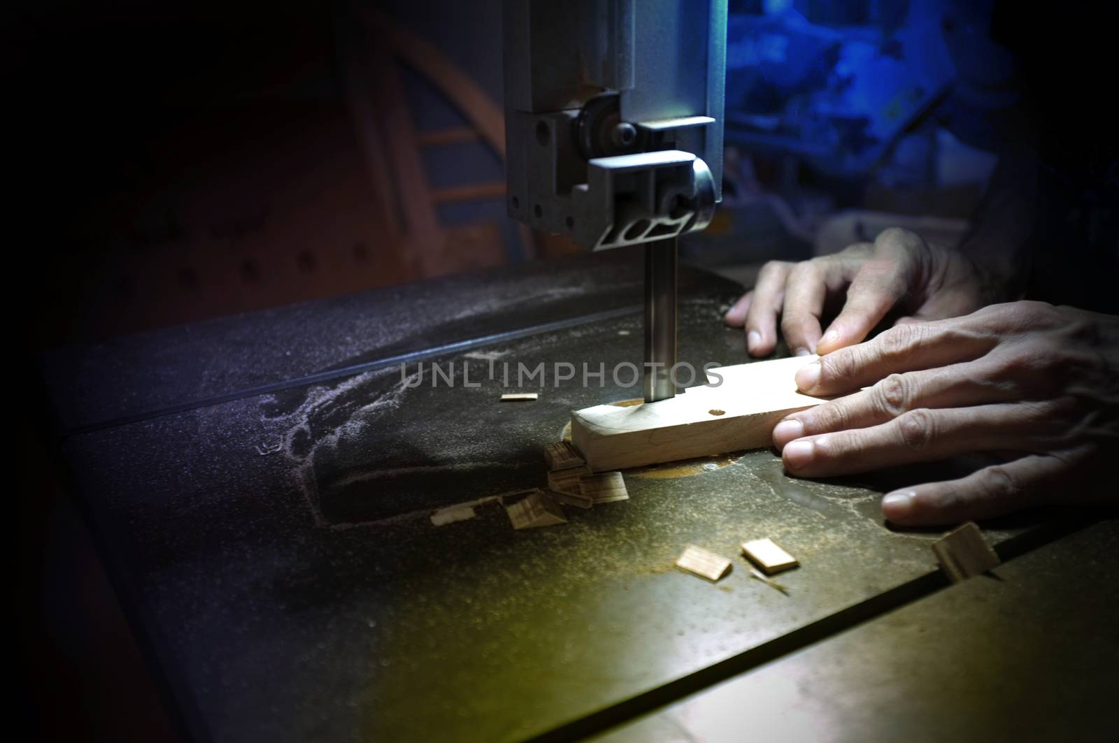 Carpenter builder working with electric jigsaw and wood. Woodworker cutting a piece of wood  