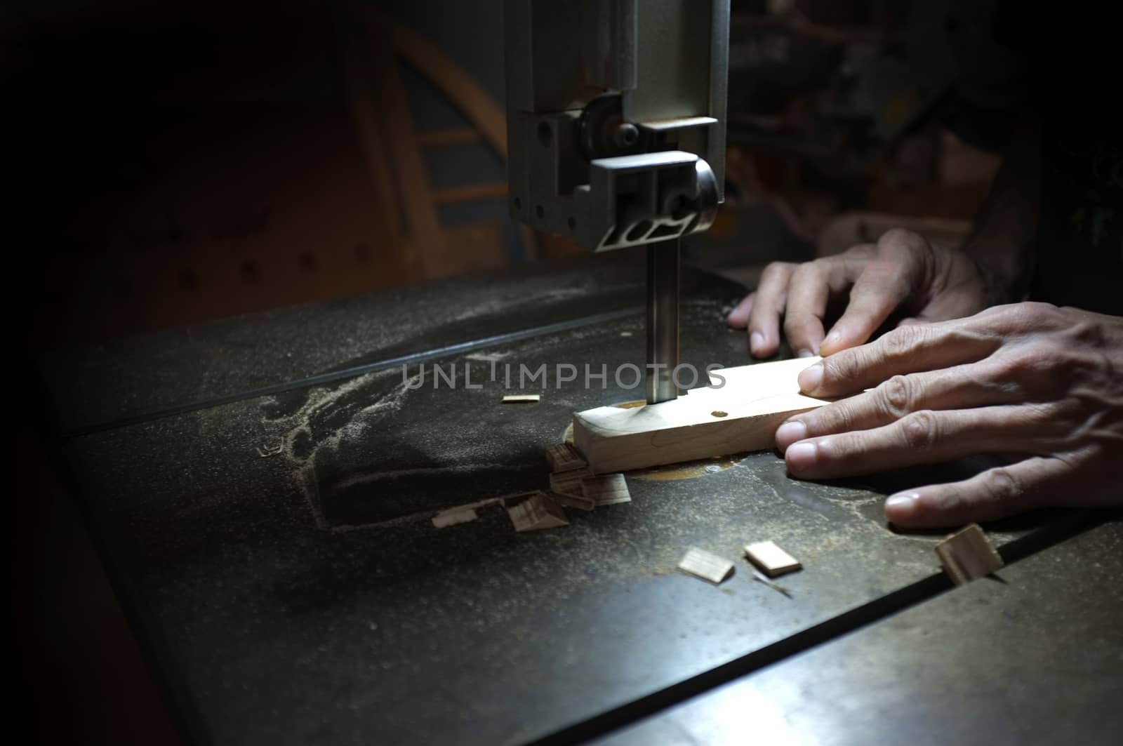 Carpenter builder working with electric jigsaw and wood. Woodworker cutting a piece of wood  