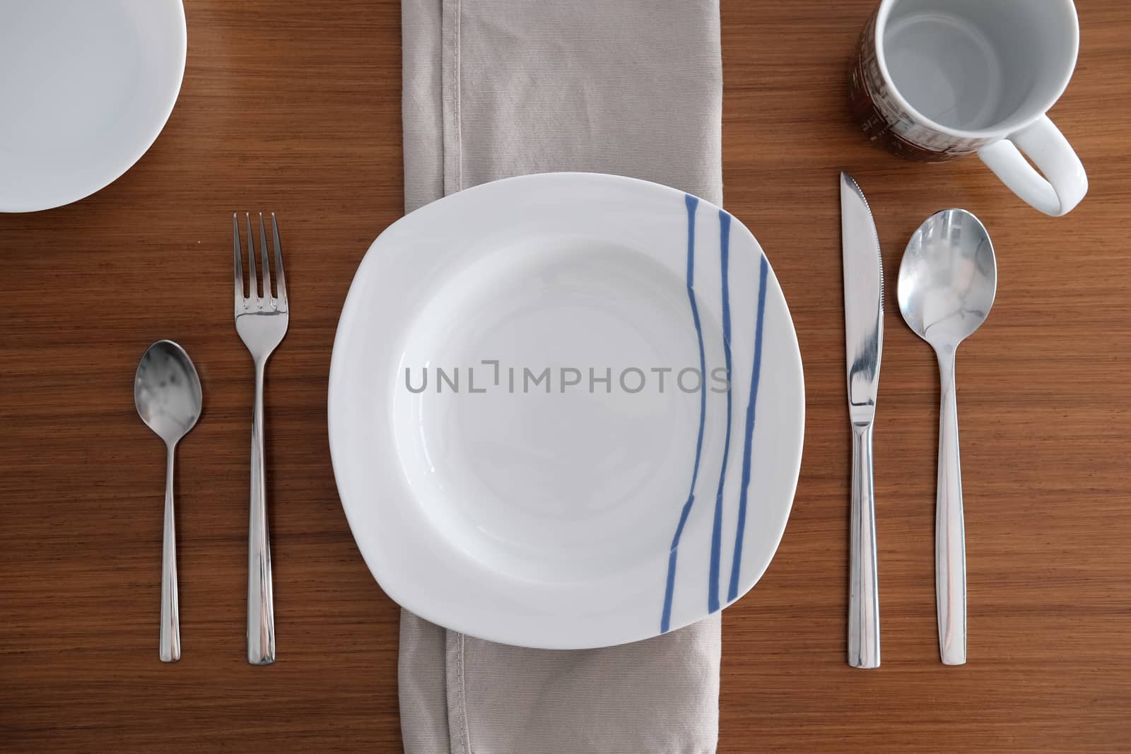 Table set for one diner on a wooden table by mikelju