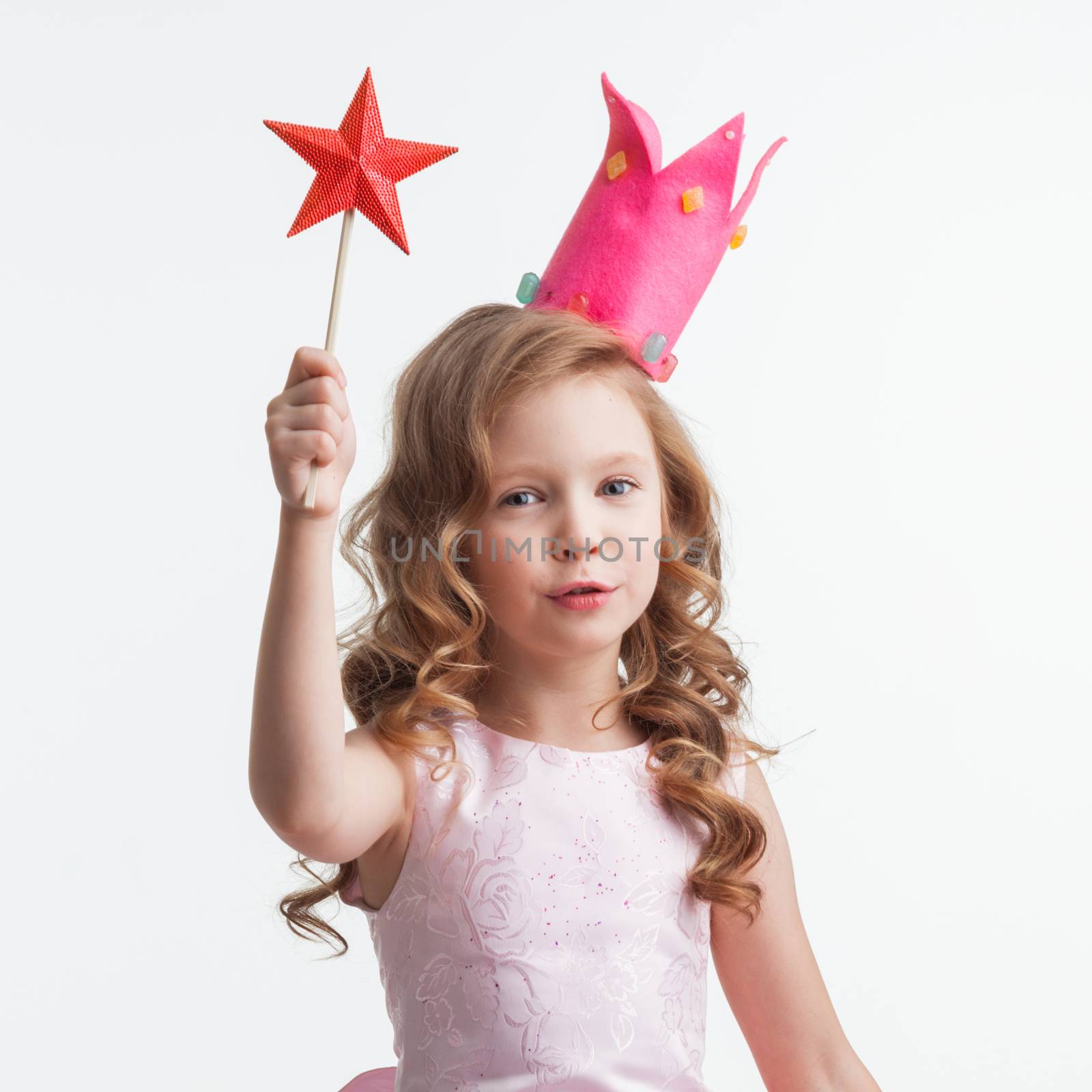 Little fairy girl in pink dress and crown with magic wand putting spell , isolated on white background