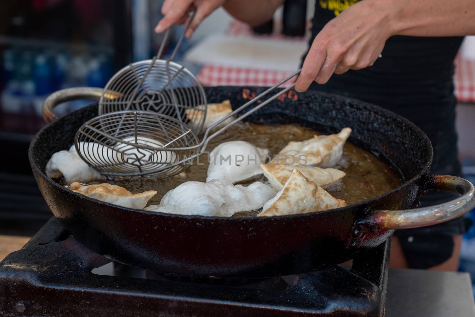 Dumplings fried in hot oil pan by Robertobinetti70