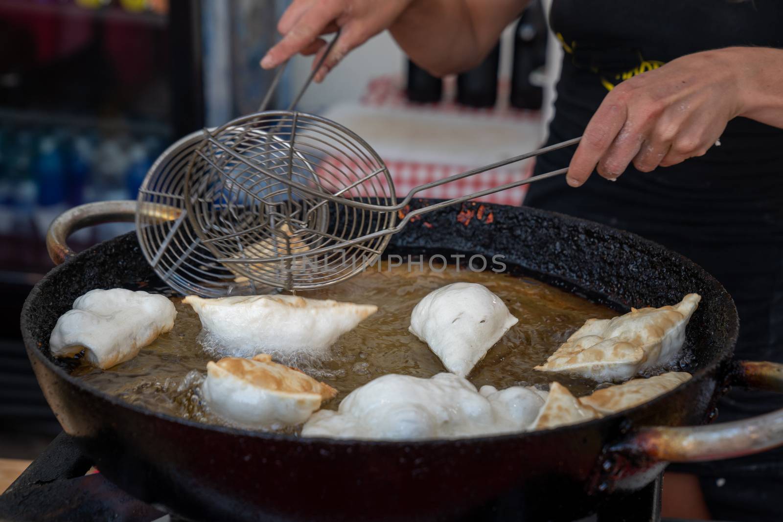 Dumplings fried,Deep Frying in hot oil pan, street food during the day,italian traditional food.