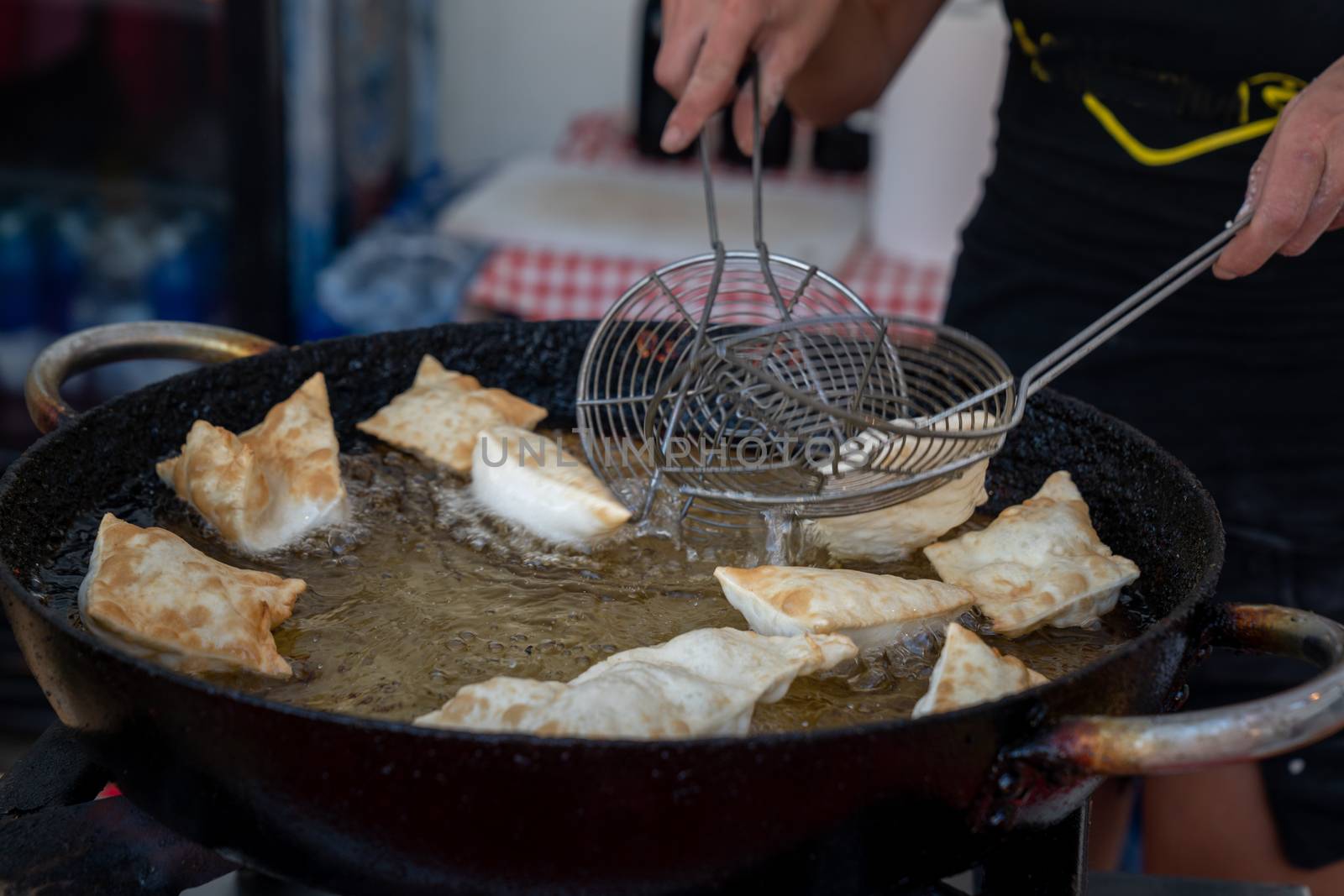 Dumplings fried,Deep Frying in hot oil pan, street food during the day,italian traditional food.