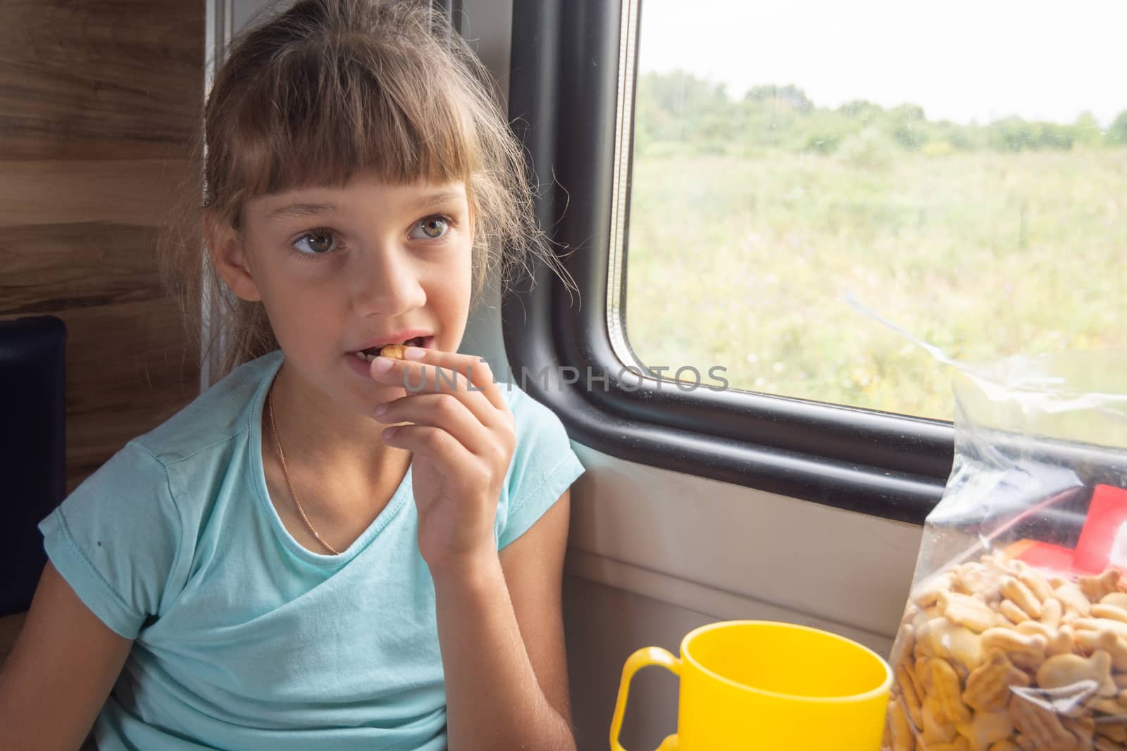 Girl eats cookies in a train