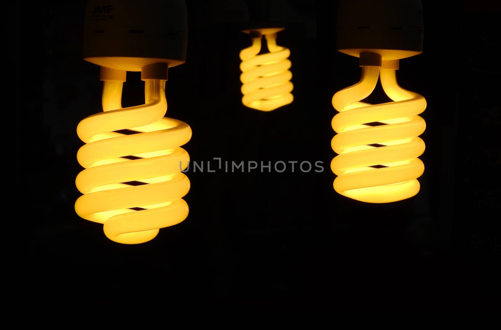 Three light bulb turn on with black background