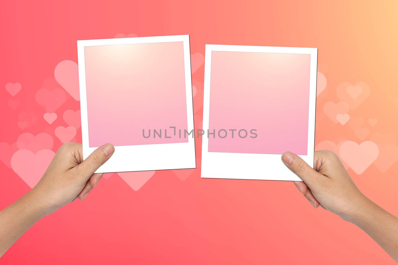 Hands hold Blank photo frame on pink Valentines Day Background Design.