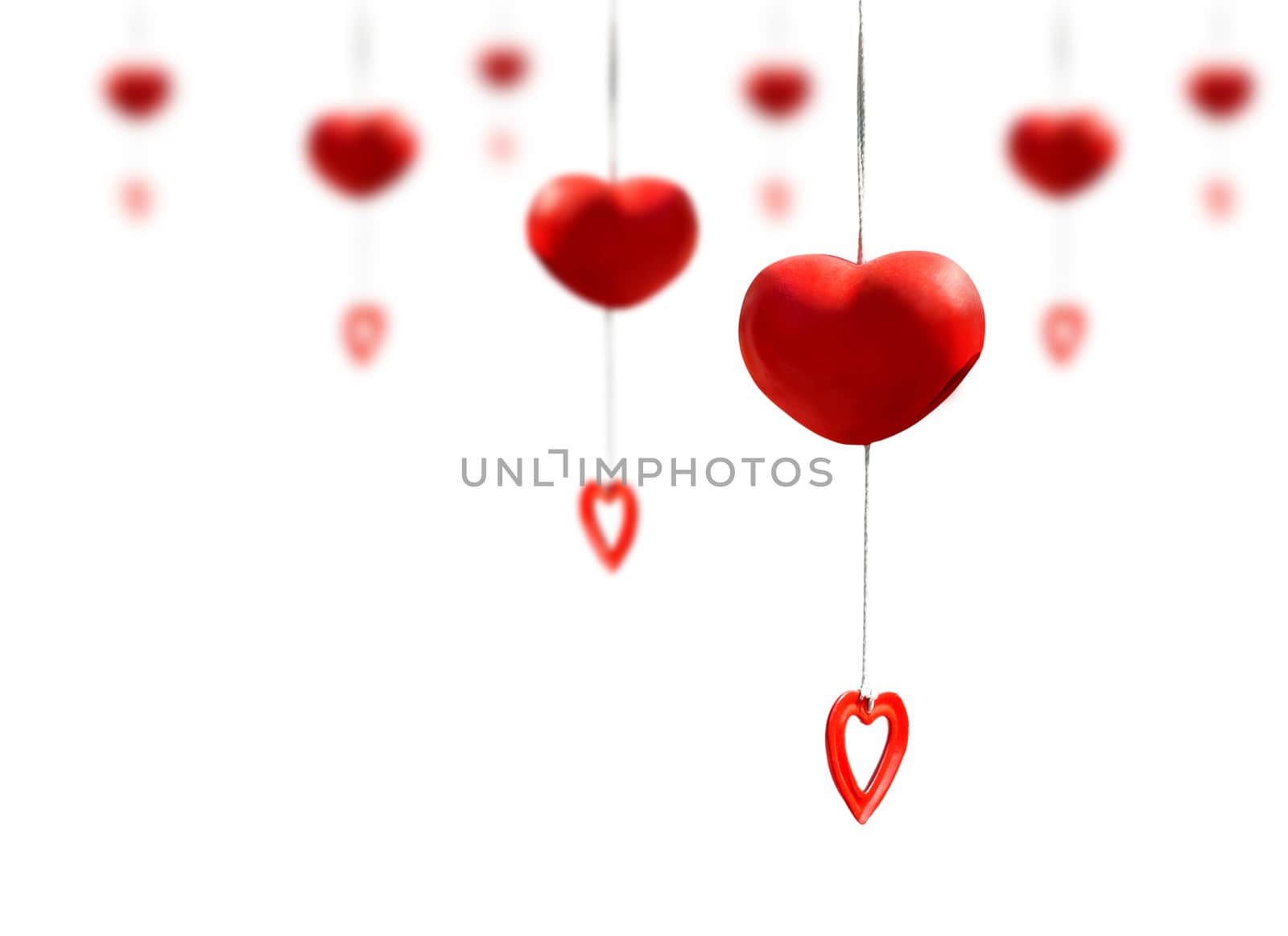 Red heart mobile made from ceramic clay hanging isolated on white background