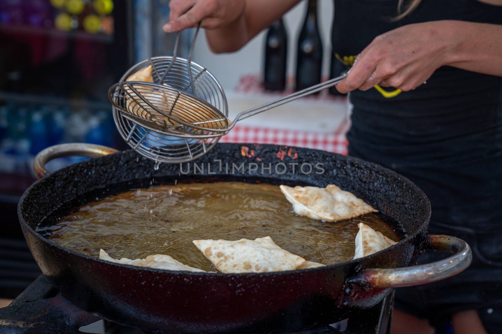 Dumplings fried,Deep Frying in hot oil pan, street food during the day,italian traditional food.