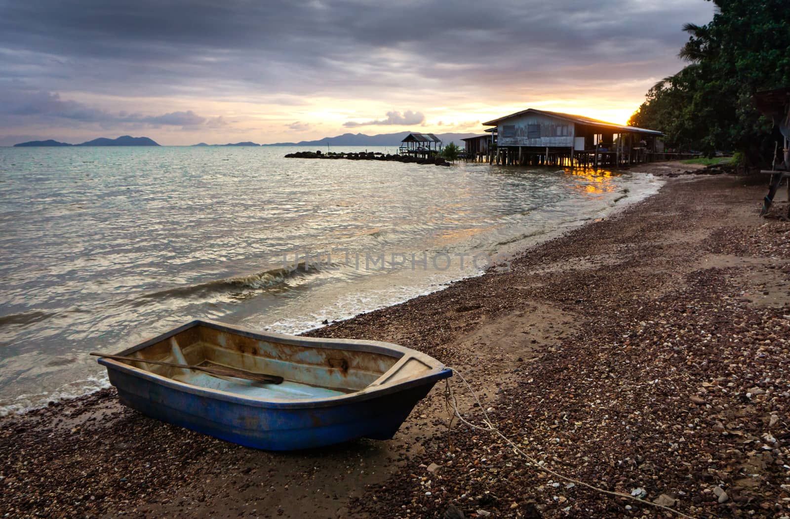 Fishing boat parked in the beach at sunset time in Thailand by pkproject