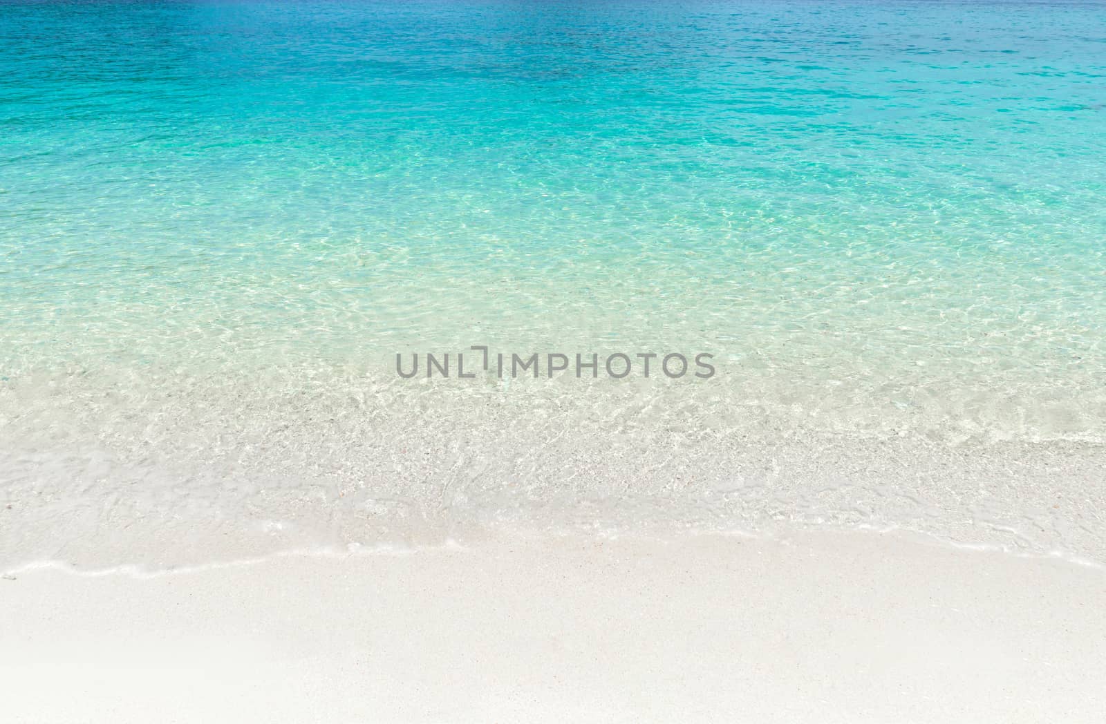 Tropical summer beach and transparent blue sea water background. Thailand sea.