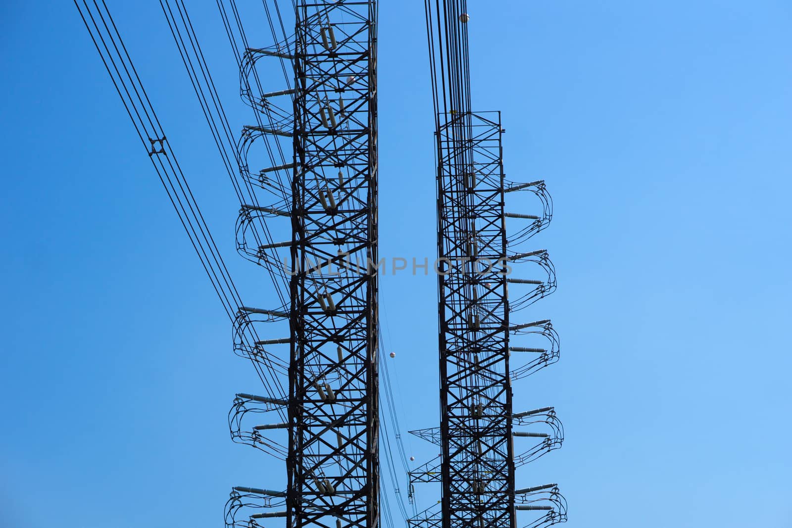 High-voltage of power transmission towers on blue sky background by pkproject