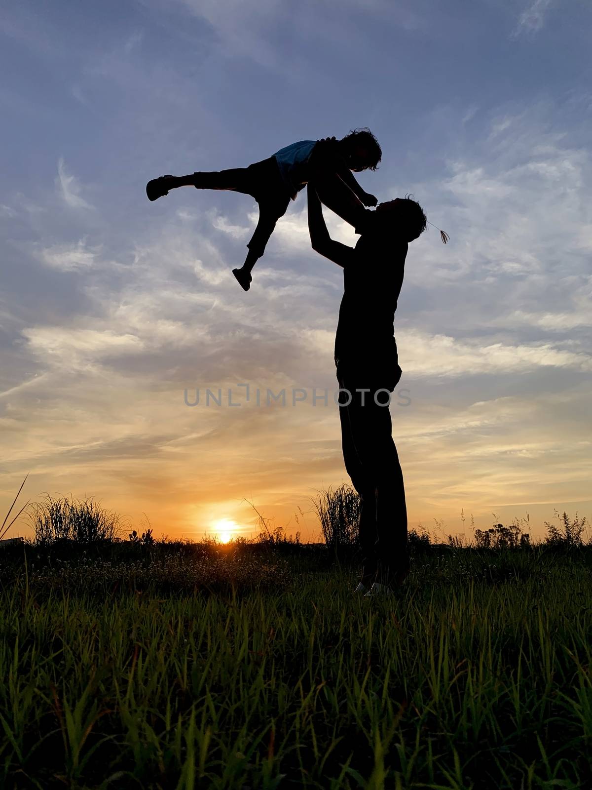 Silhouette Father Carrying Son Against Sky During Sunset.