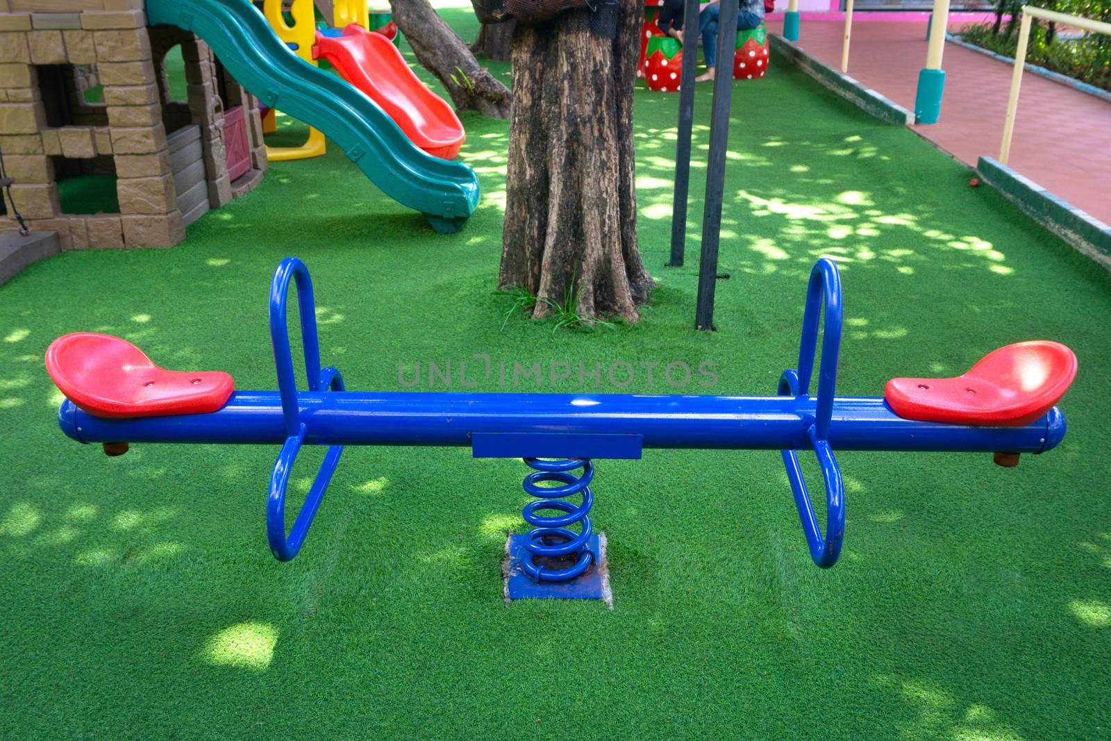 Blank blue teeterboard (or Korean plank) on the kids playground in garden.