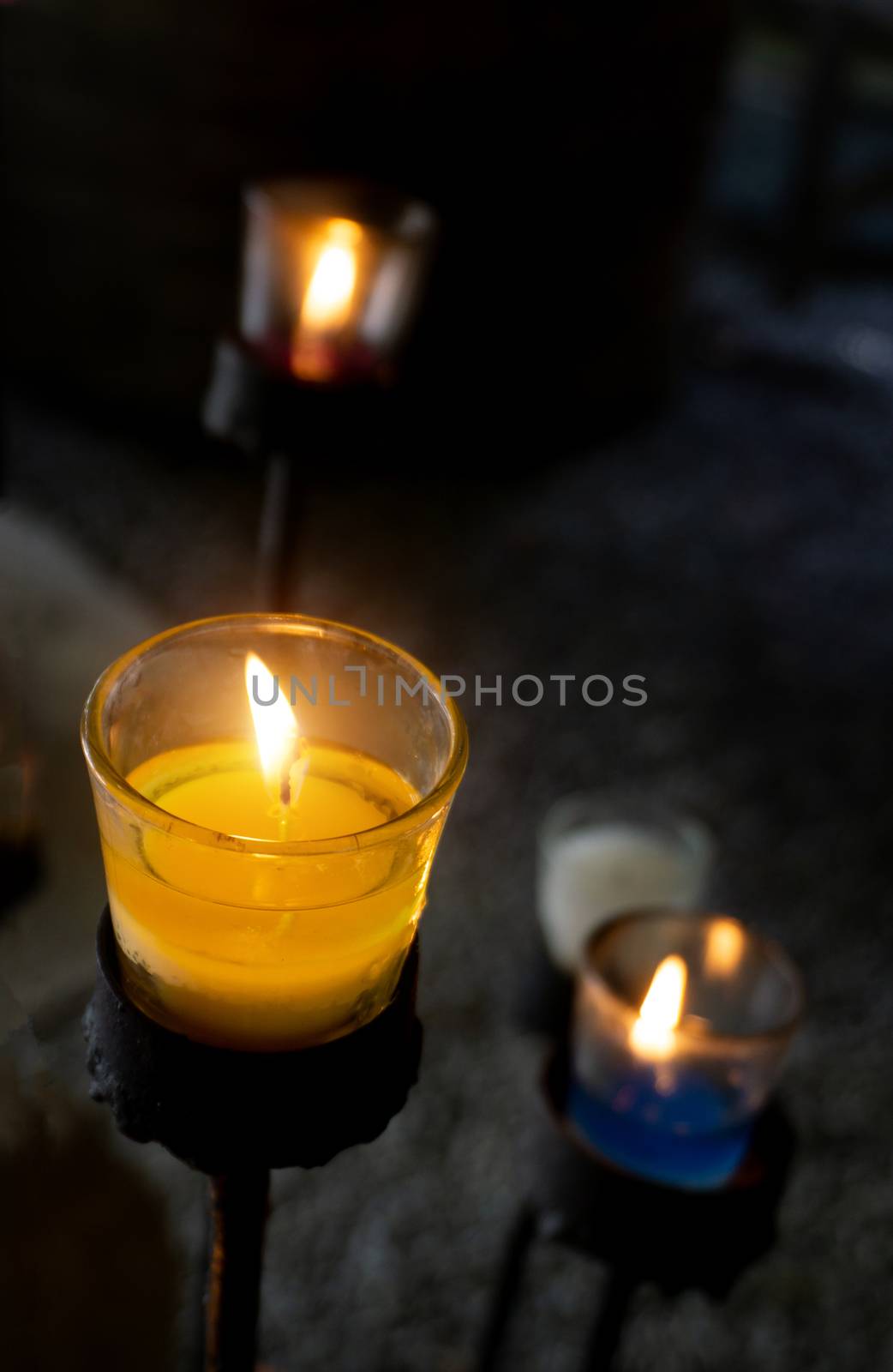 Candles placed in glass, placed on an iron base for decorations.