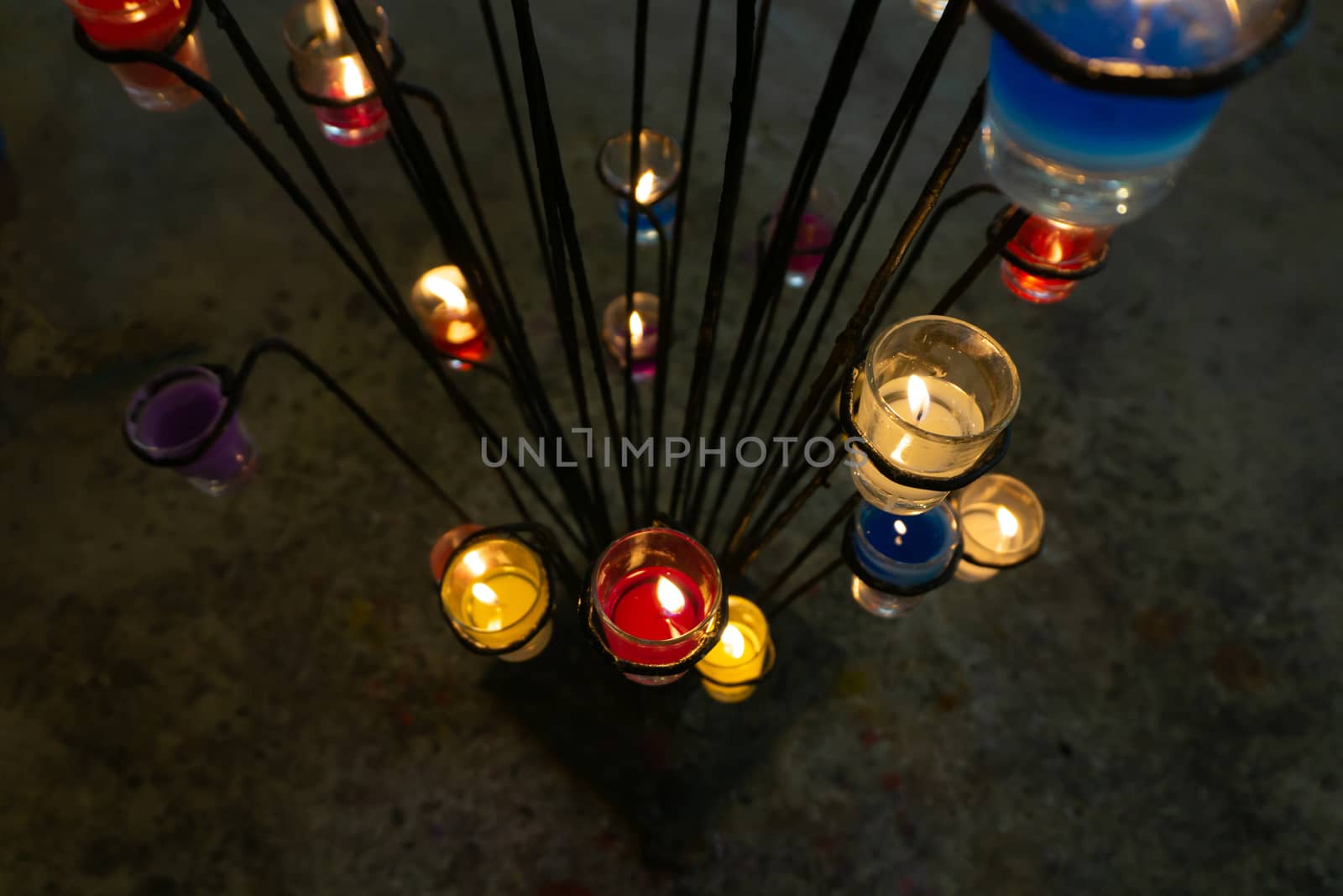 Candles placed in glass, placed on an iron base for decorations.