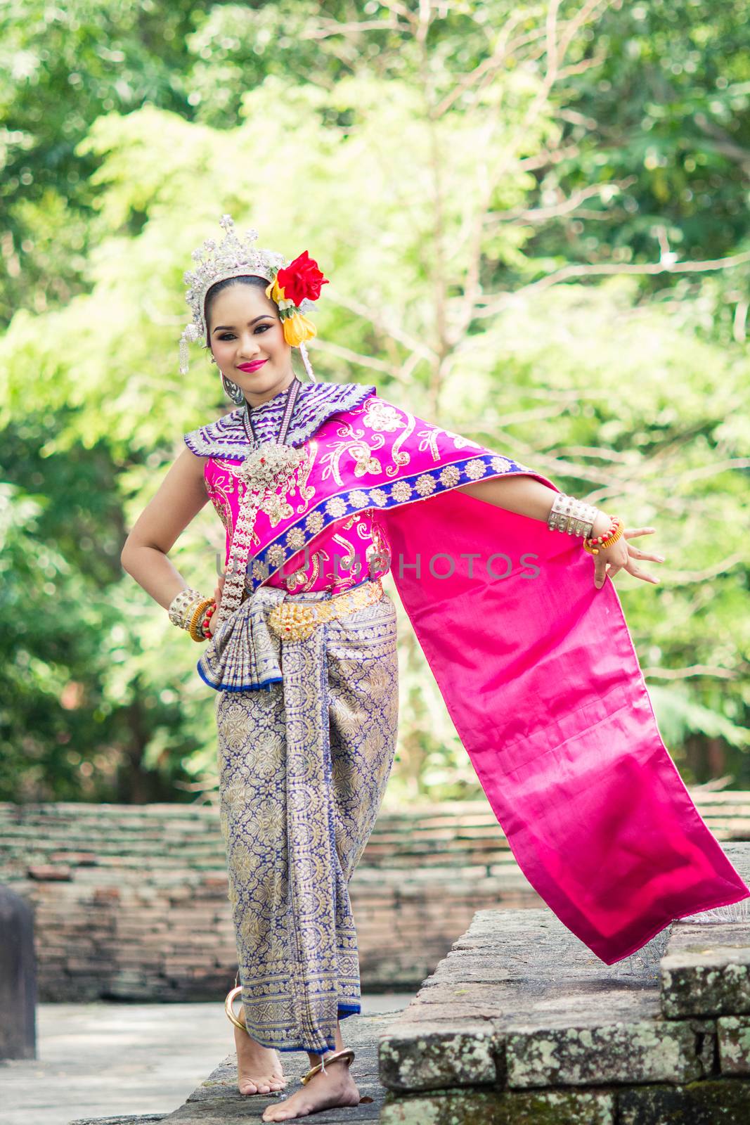 Asian woman wearing typical, traditional Thai Dress. It is liter by yuiyuize