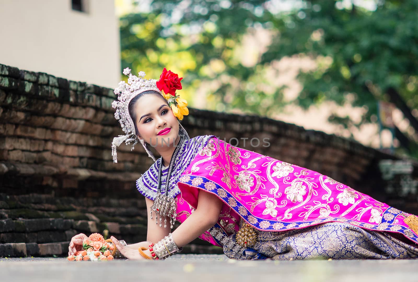 Asian woman wearing typical, traditional Thai Dress. It is liter by yuiyuize