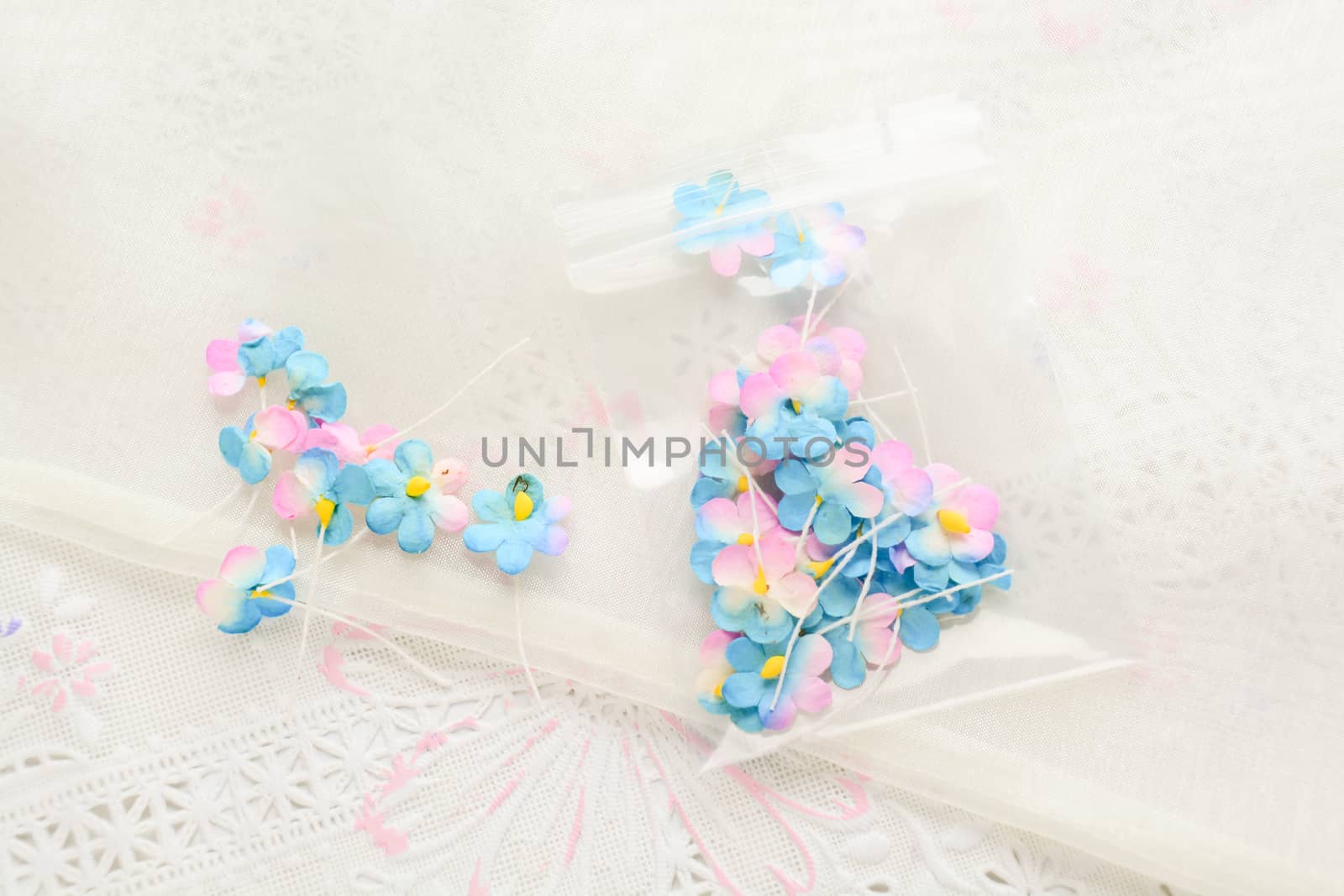 Handmade paper flowers on white fabric background, pink and yell by yuiyuize