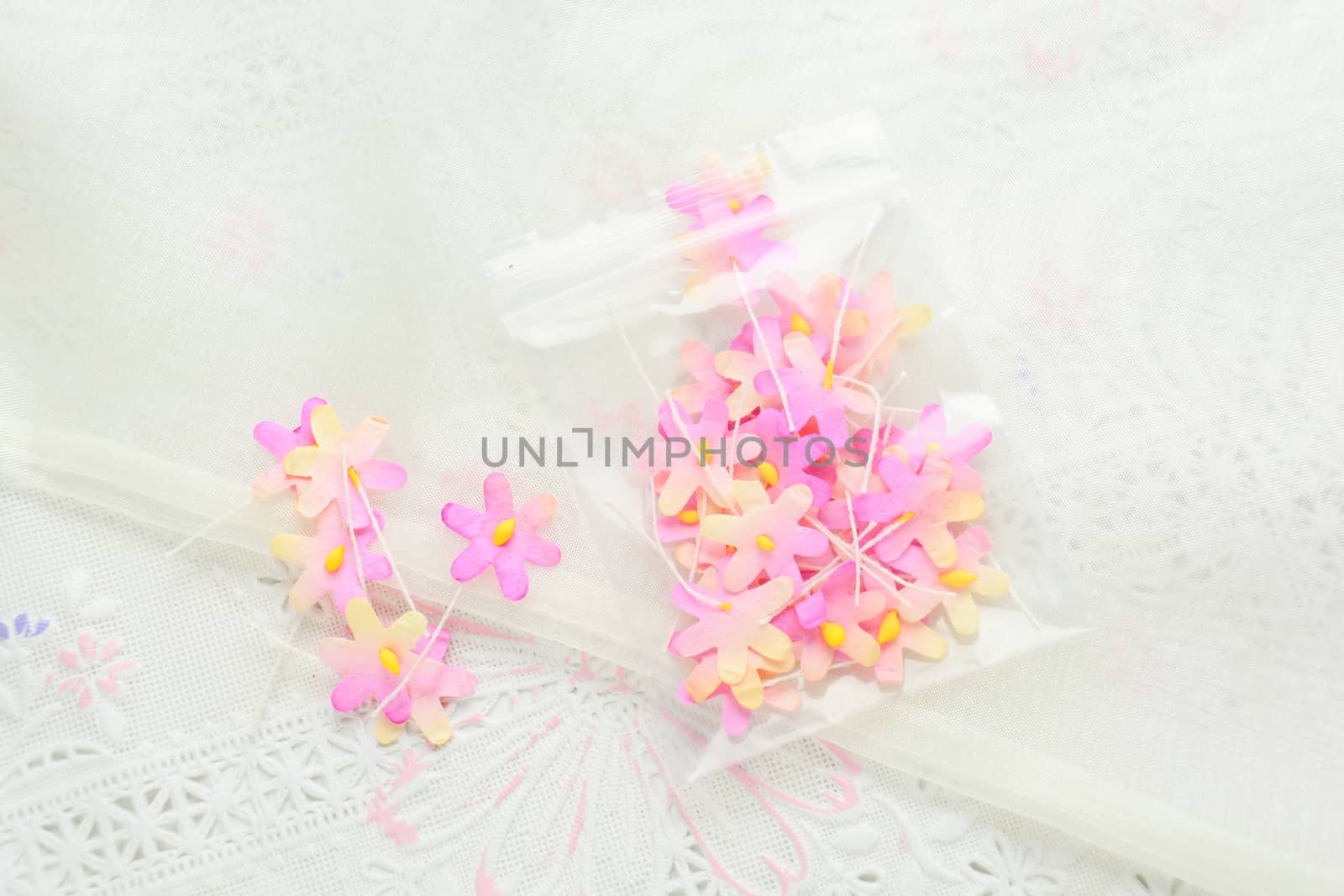 Handmade paper flowers on white fabric background, pink and yell by yuiyuize