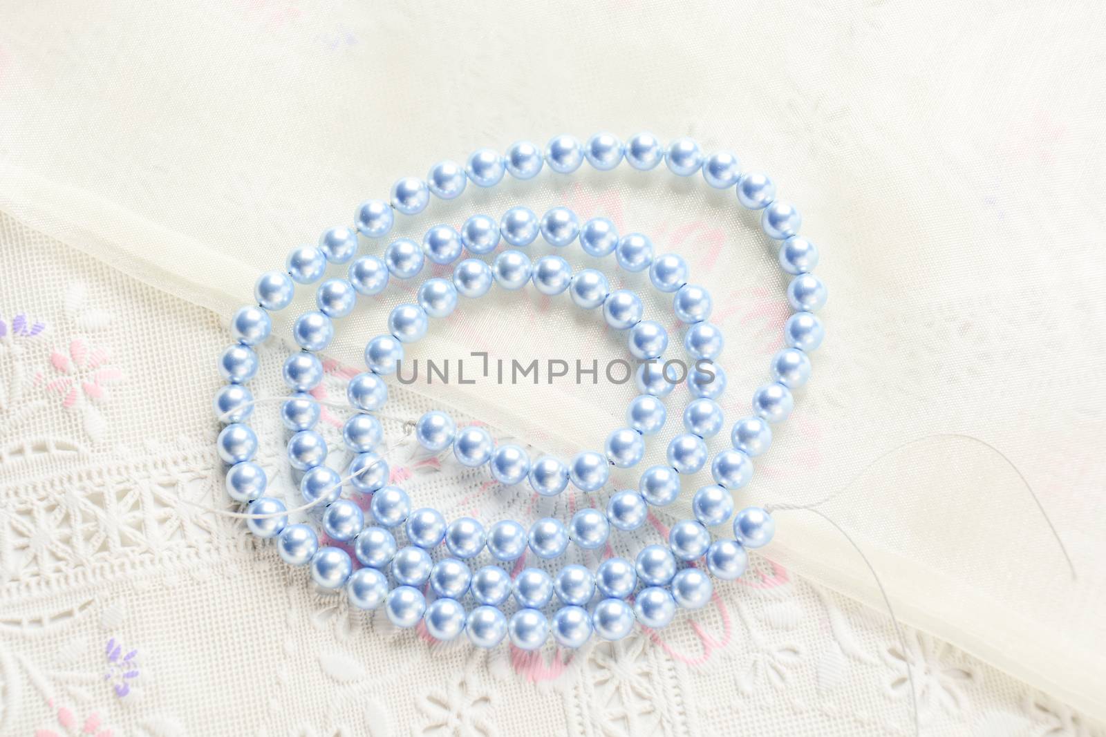 pearl necklace on white fabric background, Close up shot of glas by yuiyuize