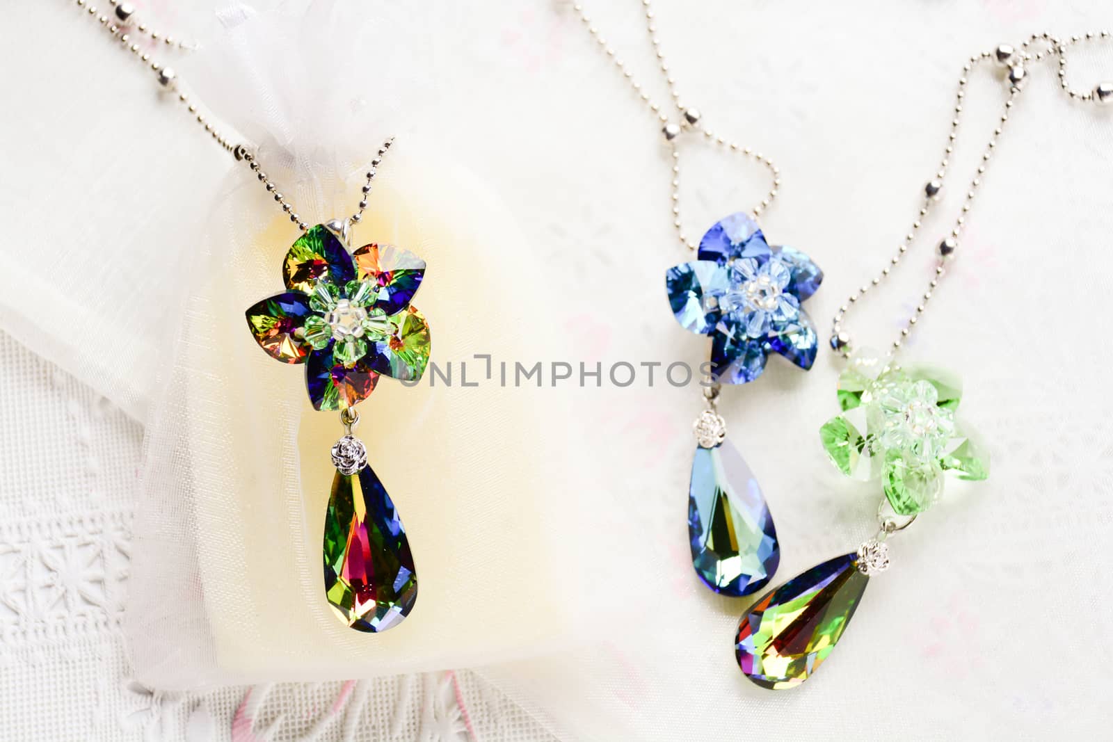 Crystal flower necklace on white fabric background by yuiyuize