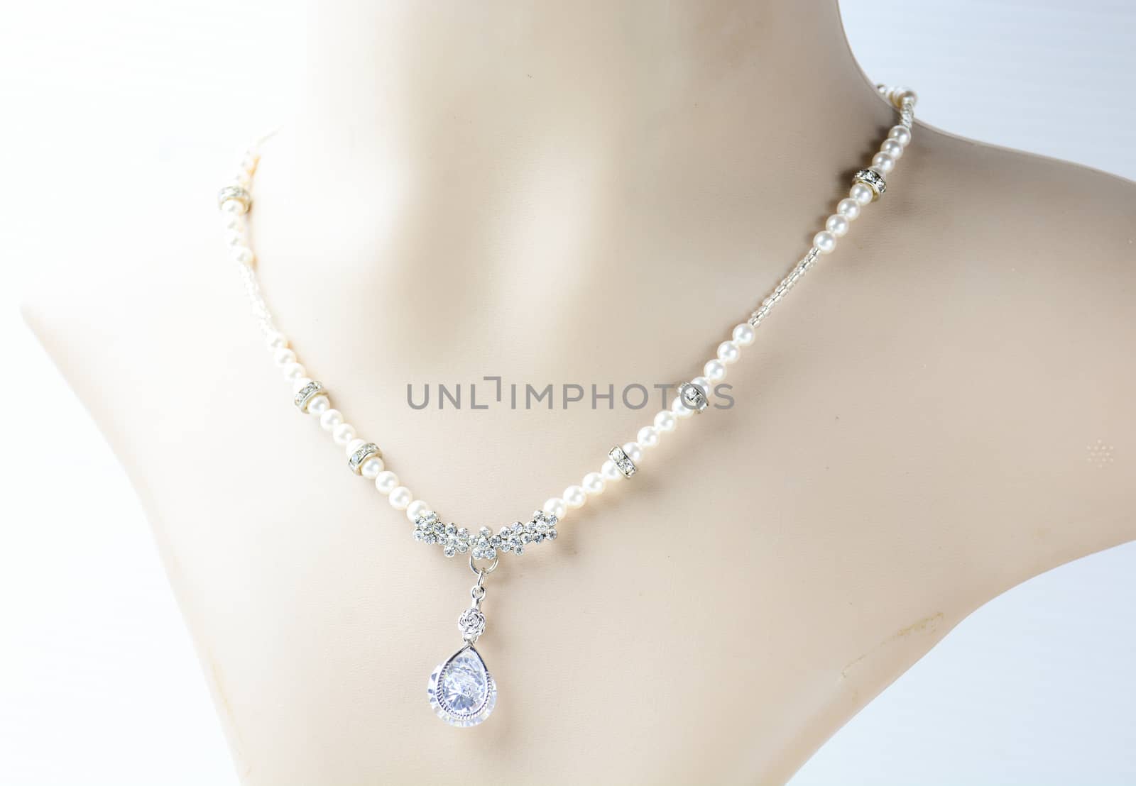 Pearl necklace on mannequin and on white background by yuiyuize