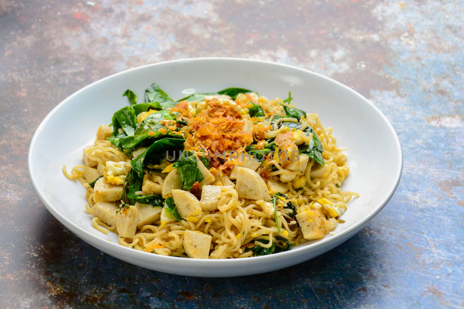 Fried noodles with Vietnamese Grilled Pork Sausage, eggs and Gnetum gnemon leaves
