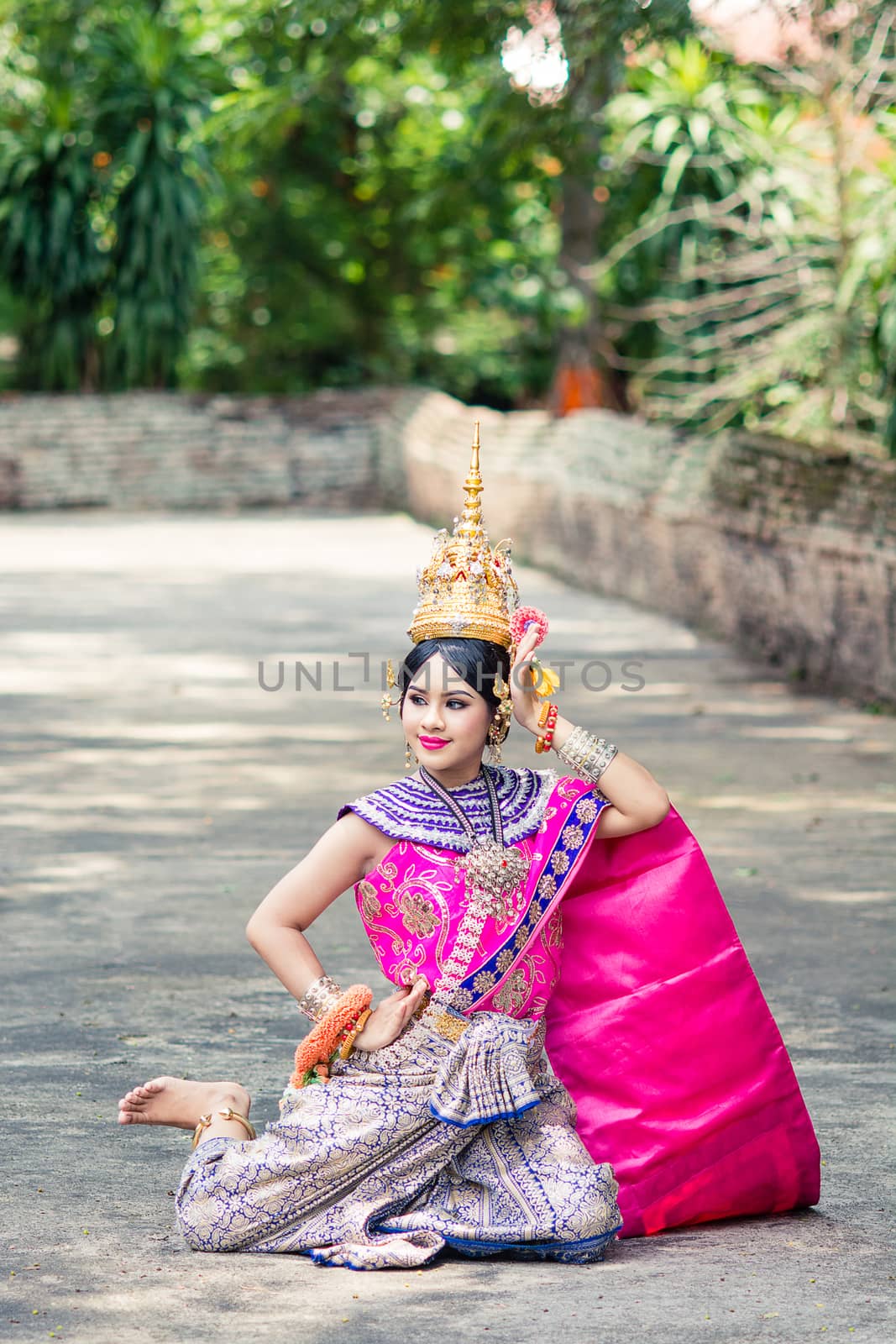 Asian woman wearing typical, traditional Thai Dress. It is liter by yuiyuize