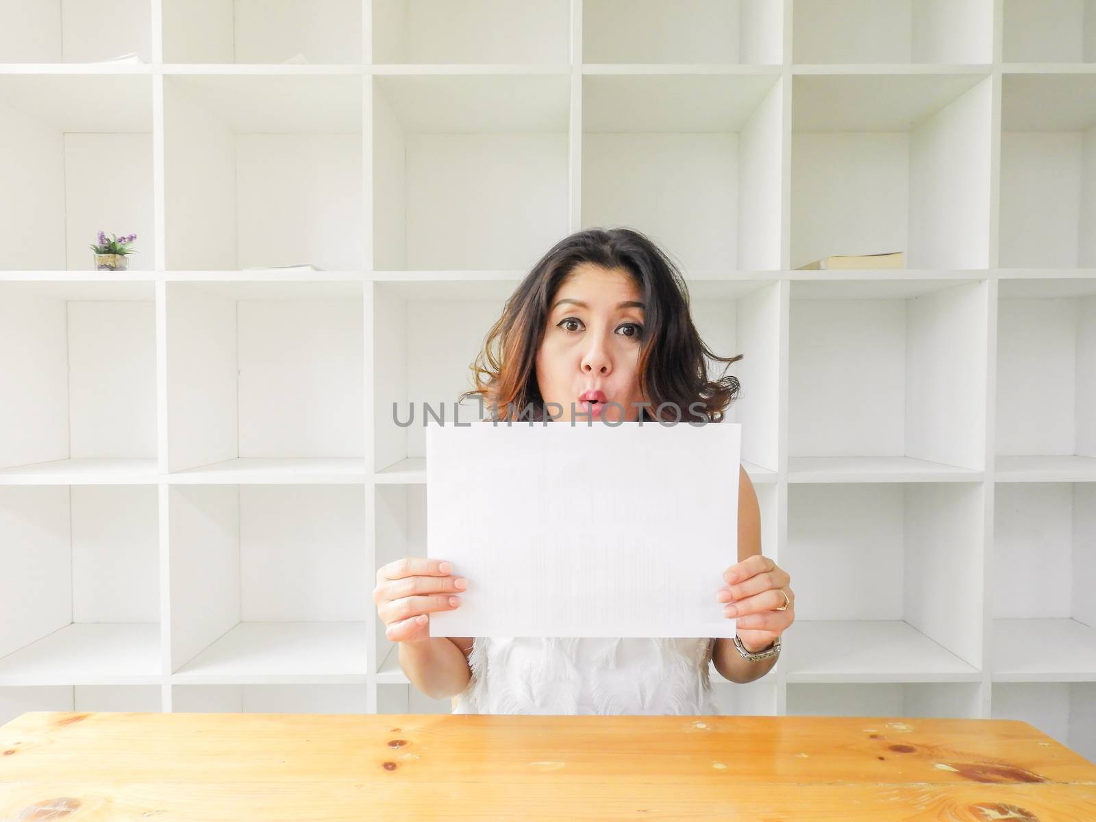 Attractive beautiful woman holding blank white paper.
