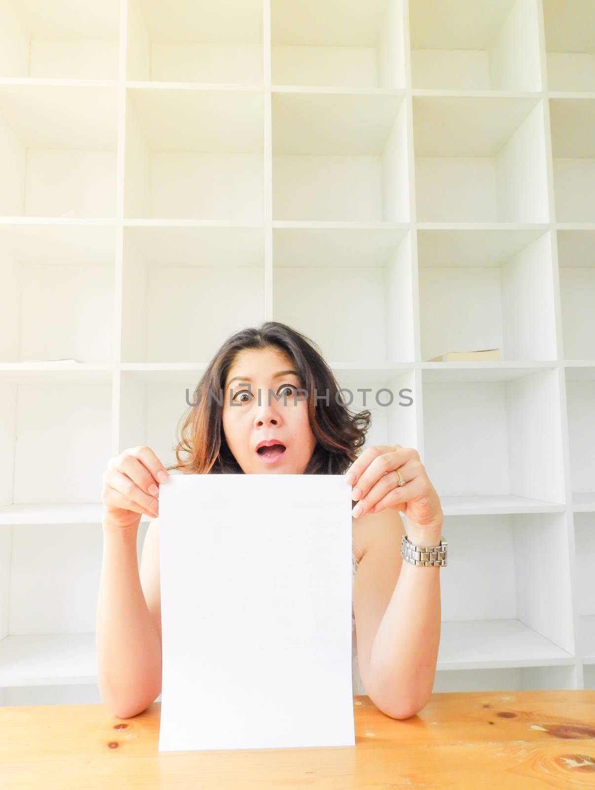 Attractive beautiful woman holding blank white paper.
