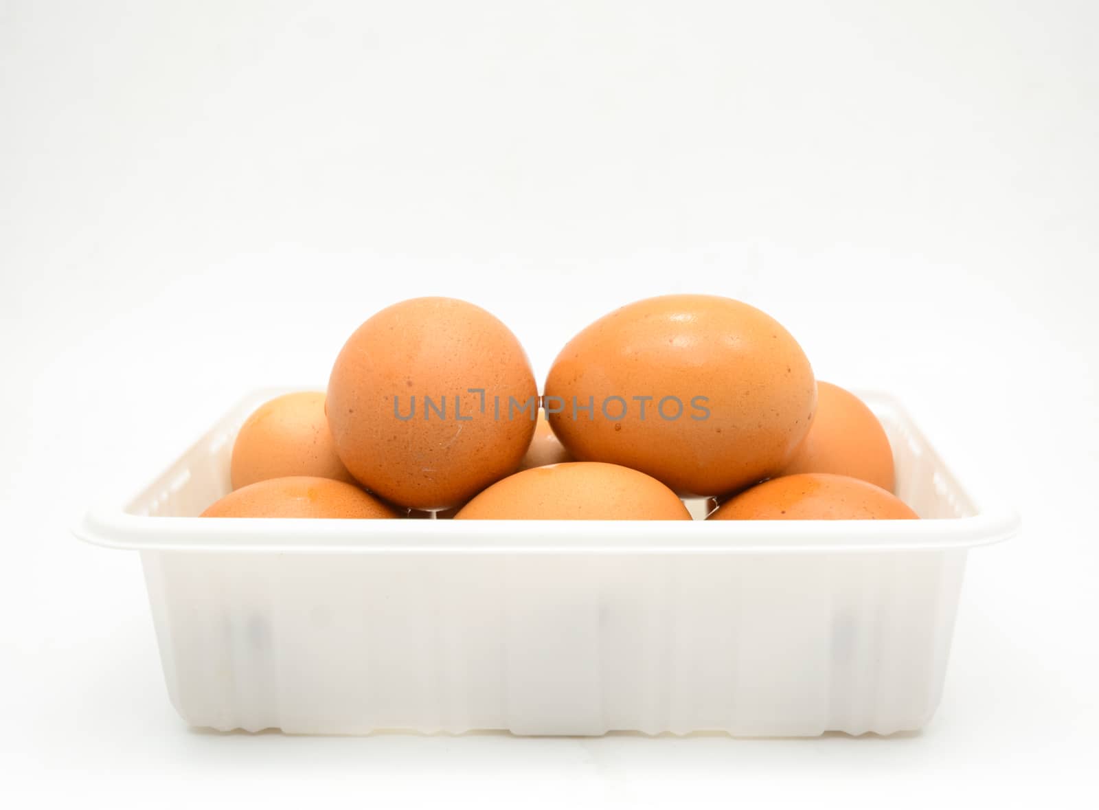 Eggs, fresh brown eggs in the white plastic box by yuiyuize