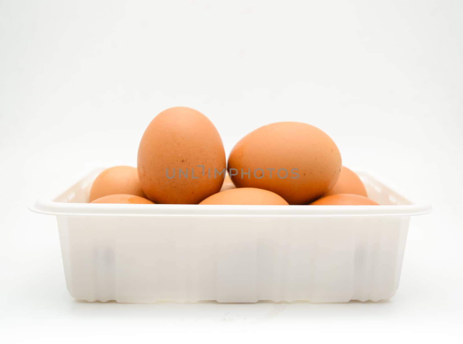 Eggs, fresh brown eggs in the white plastic box