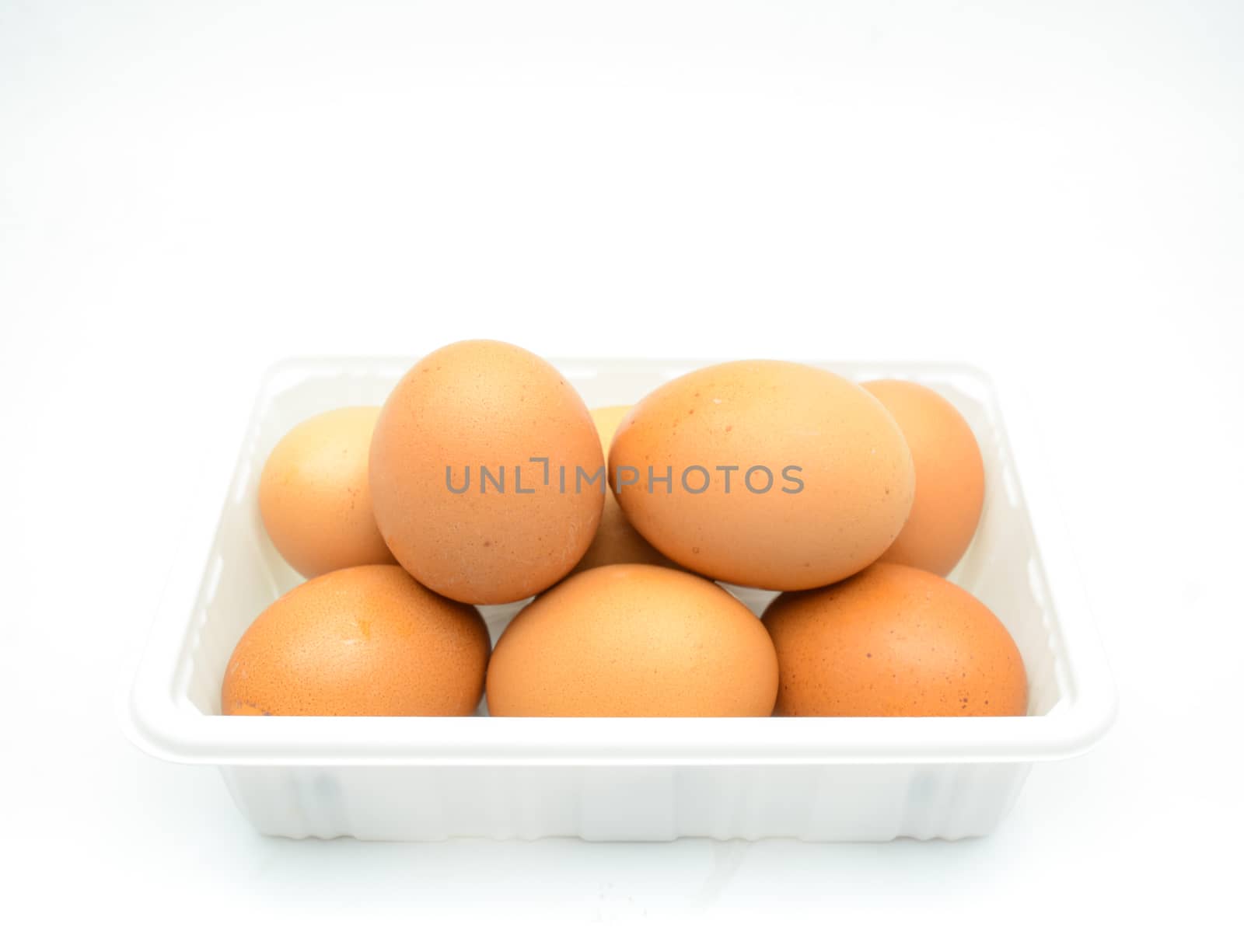 Eggs, fresh brown eggs in the white plastic box