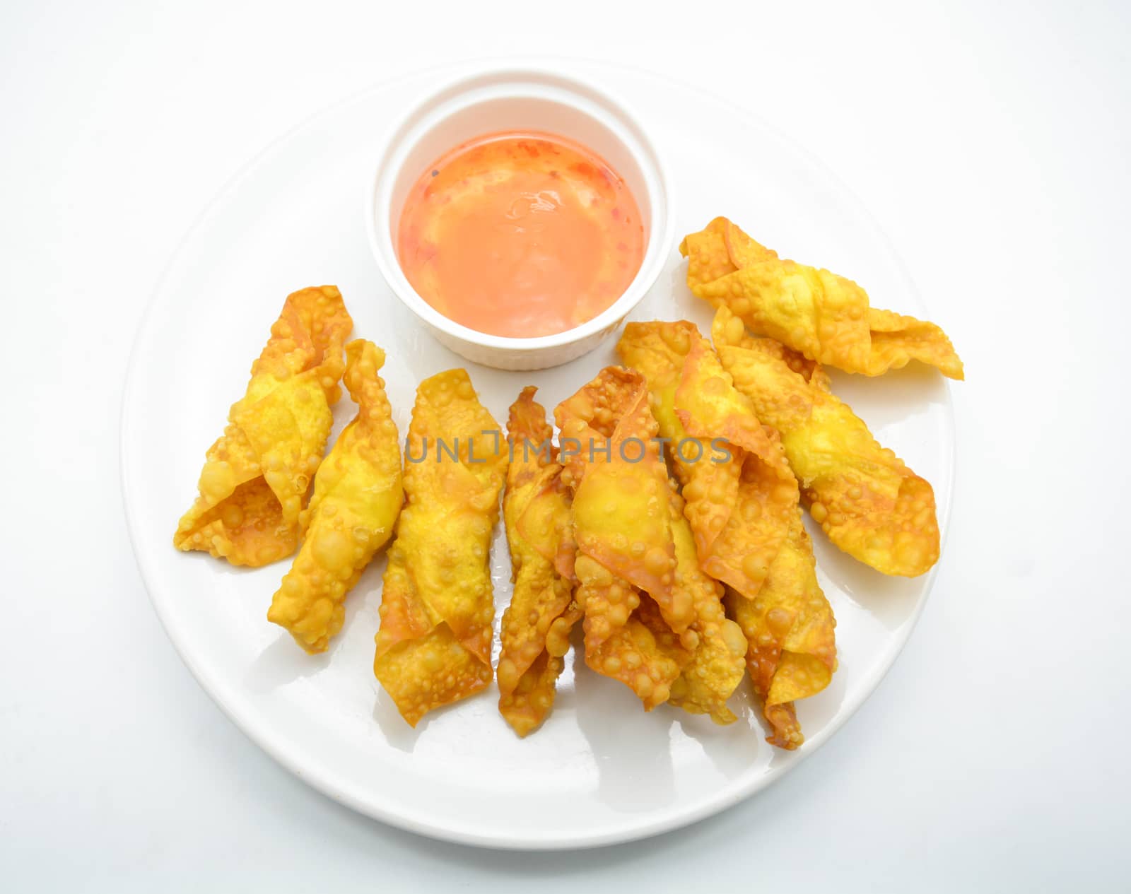 Deep Fried Won ton on white plate with dip source by yuiyuize