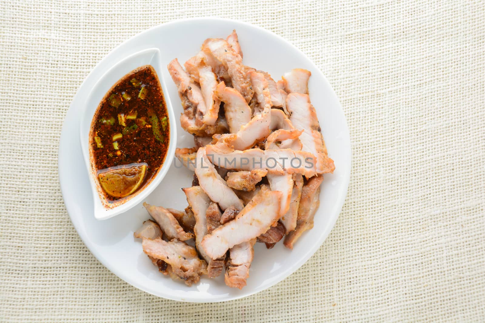 Grilled Pork with Thai Spicy Sauce, it can be served as an appetizer; it can also be served as an entrée with hot-off-the-splatter-guard sticky rice or plain steamed jasmine rice.