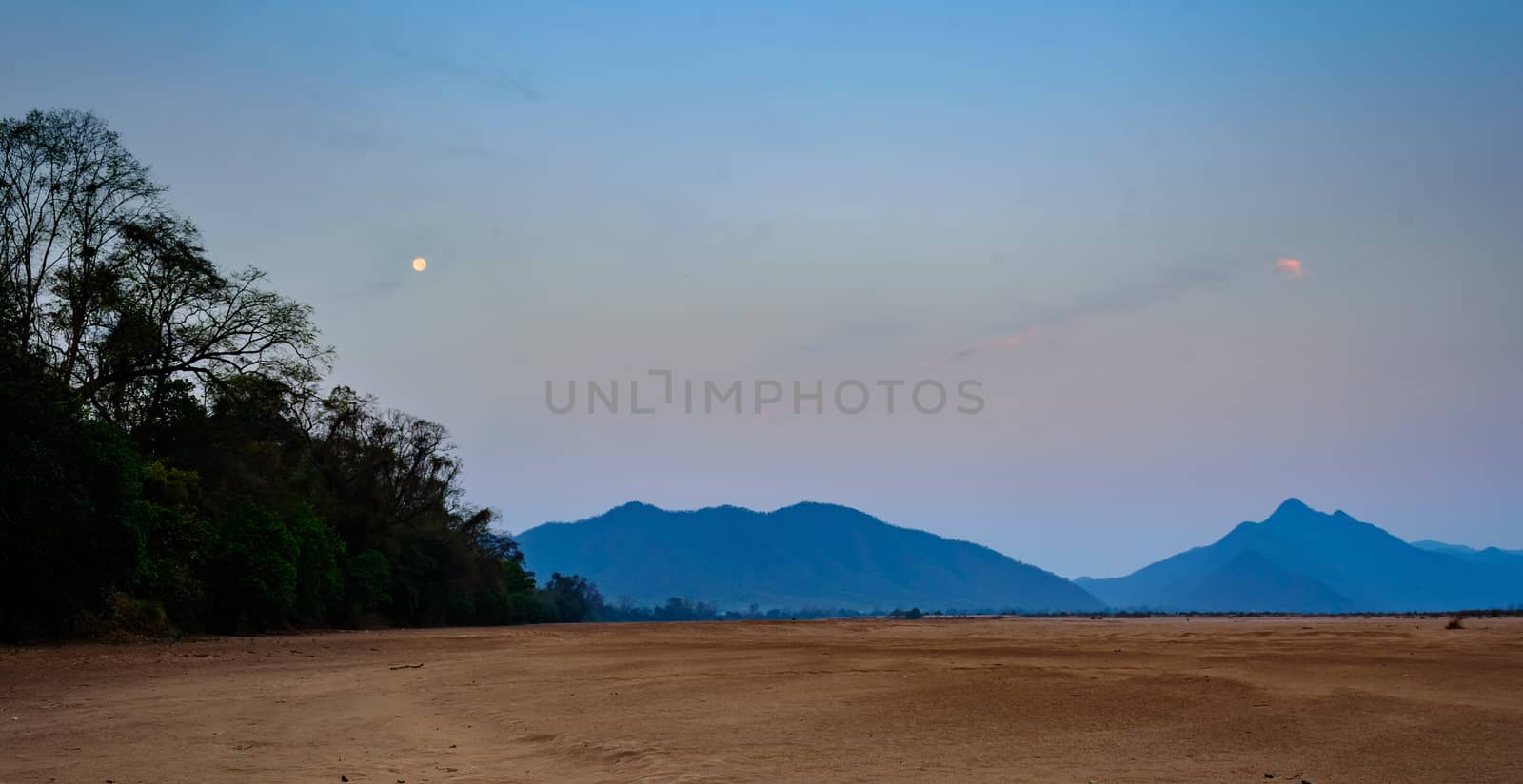 Landscape of Eastern Ghat Mountains and Mahanadi River bed as the moon sets and the dawn arrives with copy space