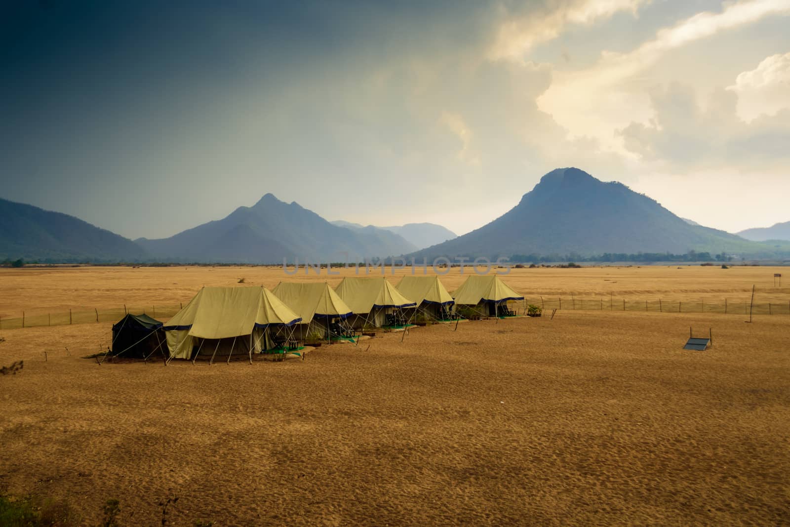 Swiss tents in the sand surrounded by Eastern Ghat mountain range with copy space