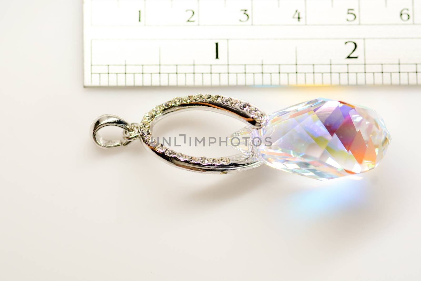 Crystal pendant on white fabric background
