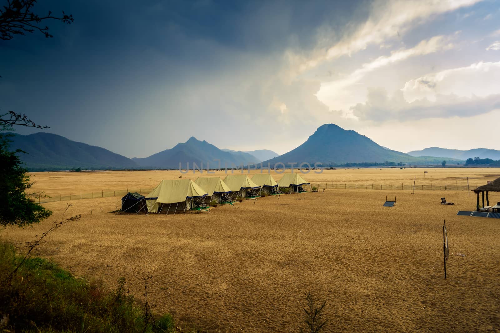 Swiss tents in the sand surrounded by Eastern Ghat mountain range with copy space
