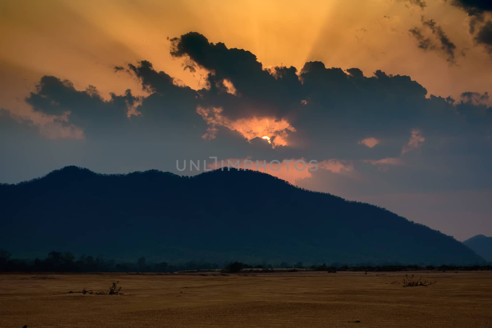 Sun settin behind Eastern Ghat Mountain range over Mahanadi river, copy space