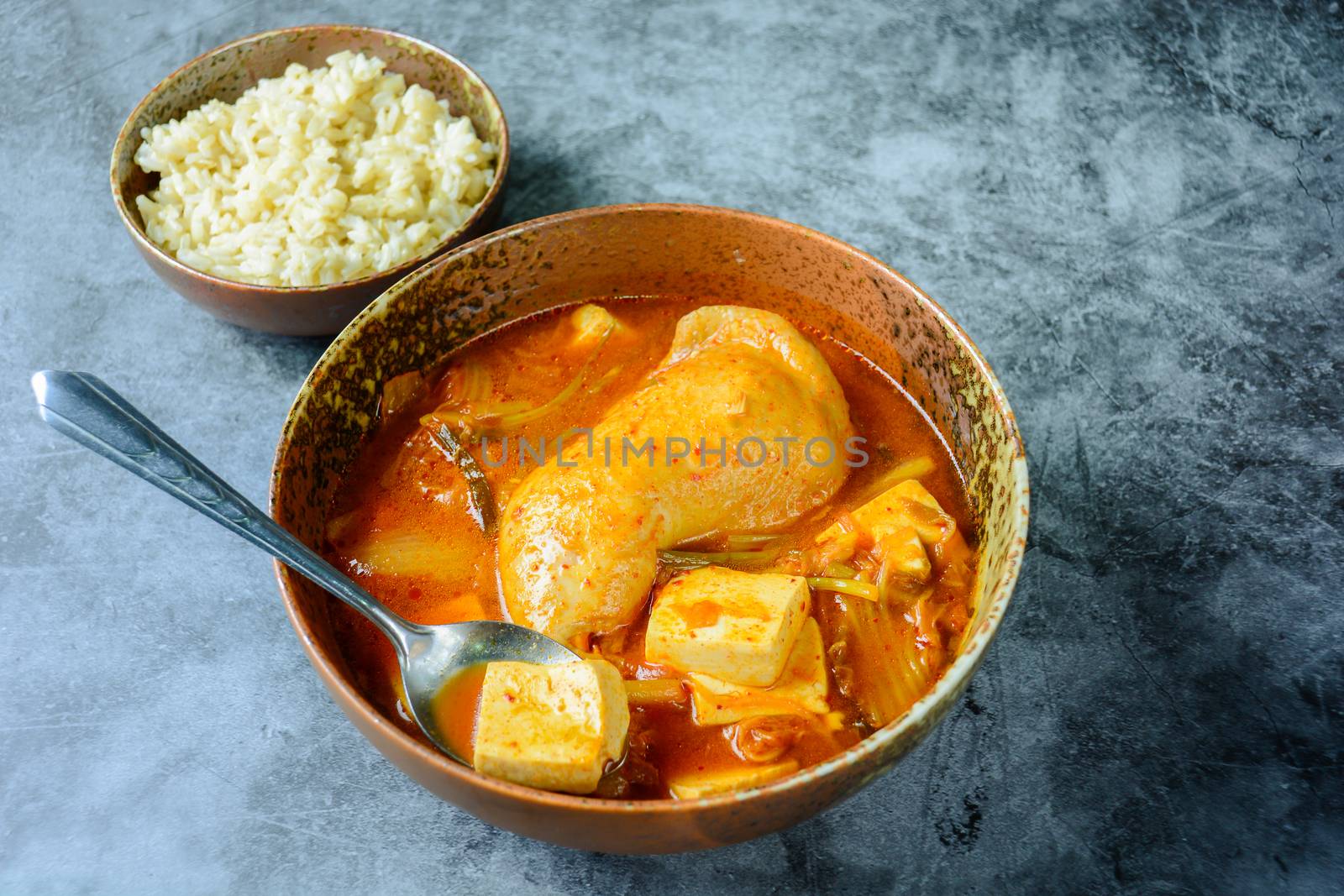 Korean traditional Kimchi soup with chicken and soft tofu
