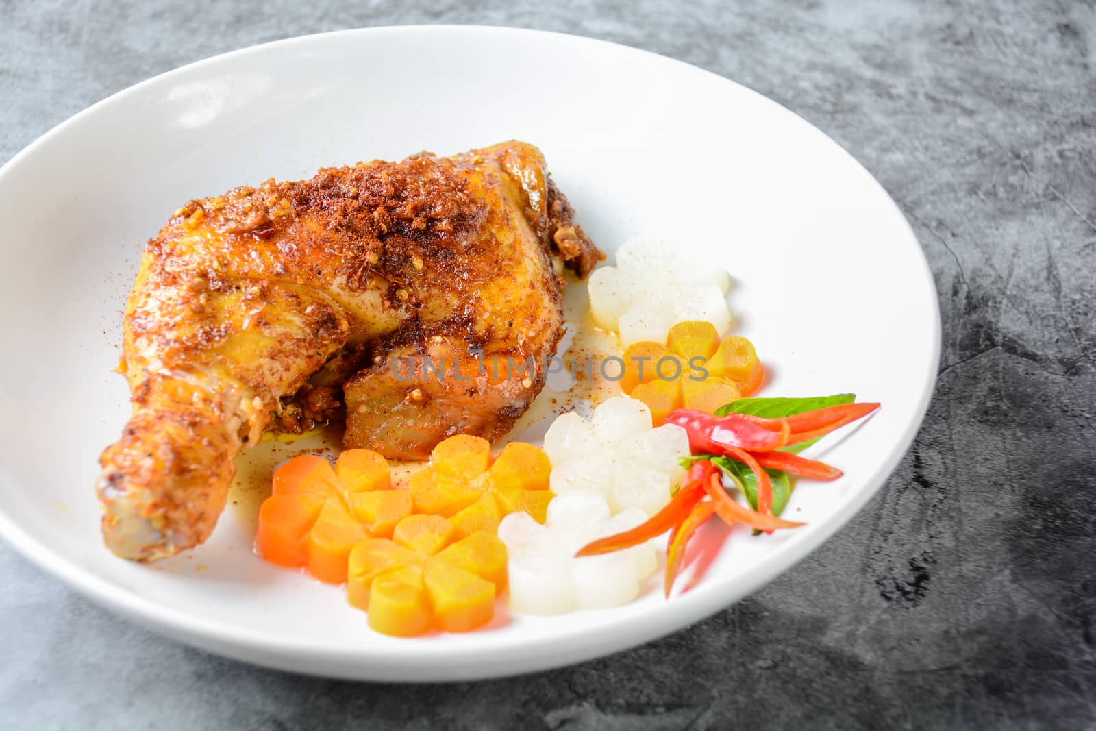 Hot and spicy baked chicken on white plate by yuiyuize